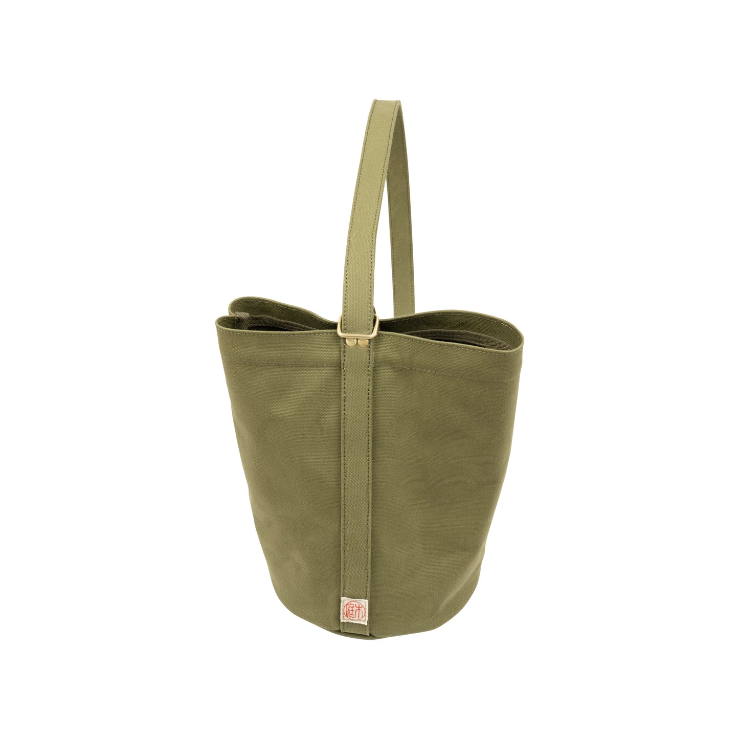 The Mini Kantan Bag - Green features water-resistant canvas, a single handle, vertical seam detail, and a small square logo patch near the base, shown against a white background.