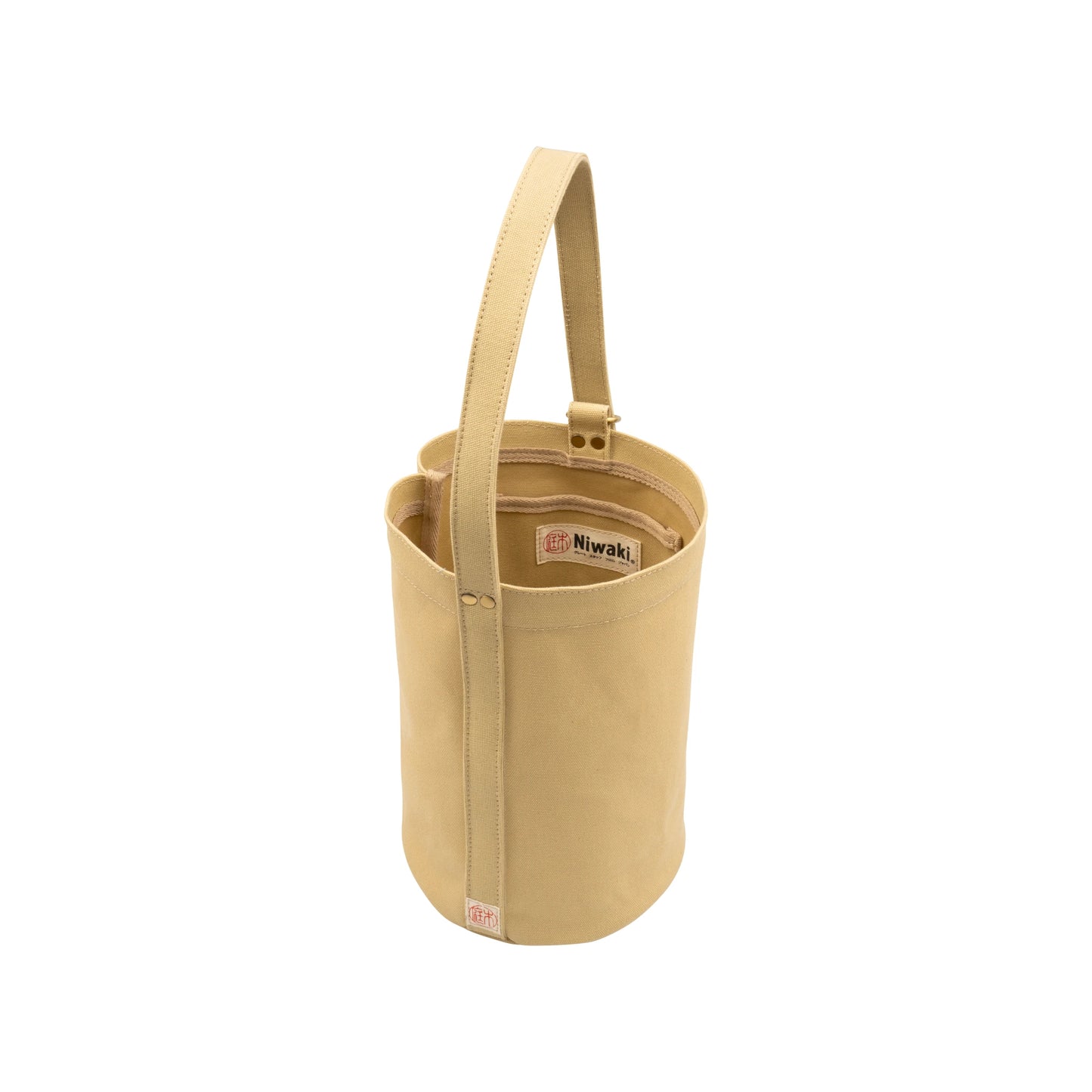 Mini Kantan Bag - Tan with handle, Niwaki label, and internal compartments. This everyday water-resistant canvas bucket bag is shown on a white background.