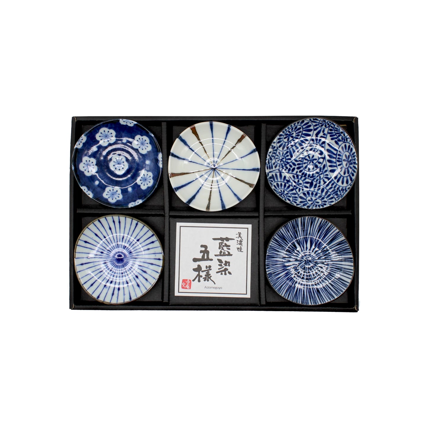 
                  
                    The 5 Piece Mini Plate Gift Set - 'Aizome' includes five mini Japanese plates with blue and white patterns, each with a center paper label, all presented in a sleek black tray.
                  
                