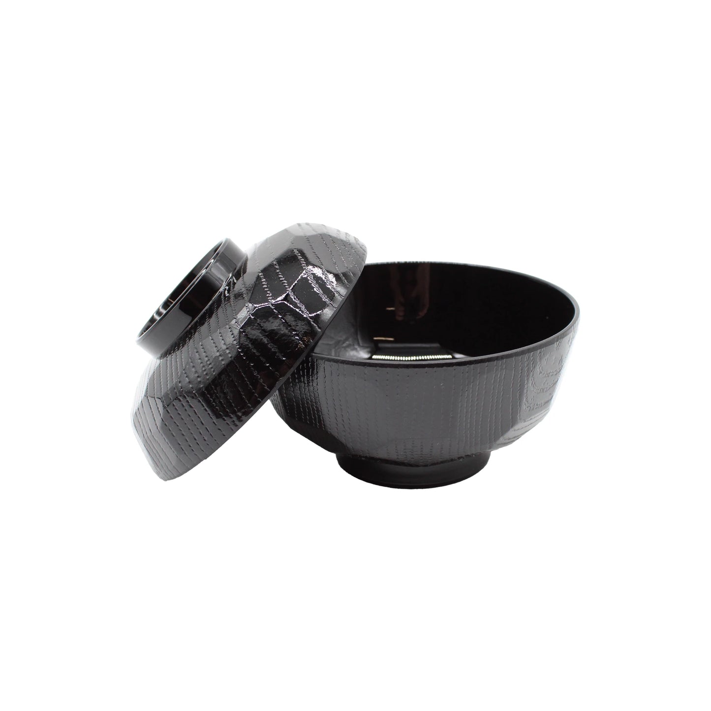 
                  
                    The Miso Bowl With Lid features a black, textured finish and comes with a matching lid slightly tilted to the side. Its glossy Japanese lacquerware design is elegantly highlighted against a white background.
                  
                
