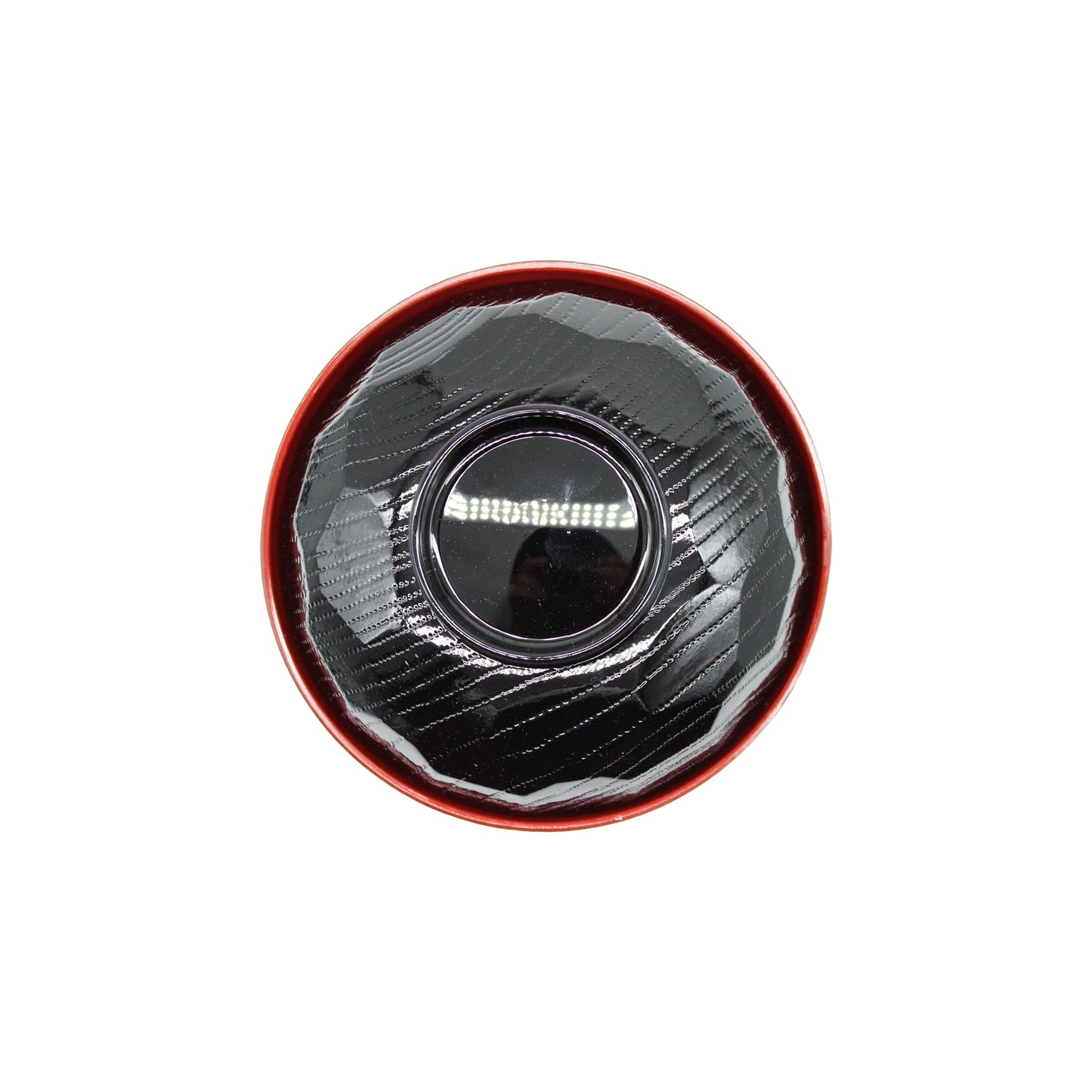 
                  
                    A top-down view of the Miso Bowl With Lid, featuring a round black textured bowl and lid, placed inside a red circular container.
                  
                
