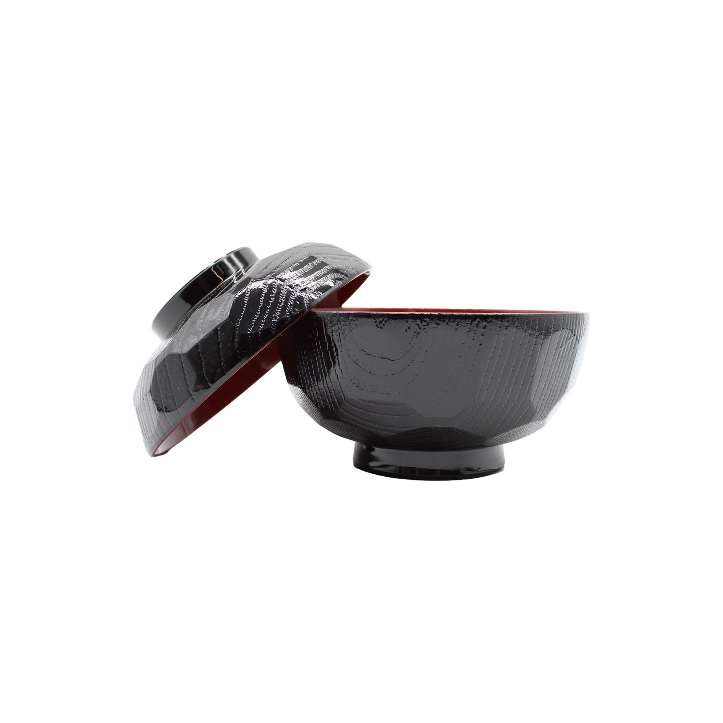 
                  
                    The Miso Bowl With Lid is made of ABS plastic and includes a matching slightly glossy black bowl and lid, inspired by Japanese lacquerware. The lid is shown resting at an angle against the bowl.
                  
                