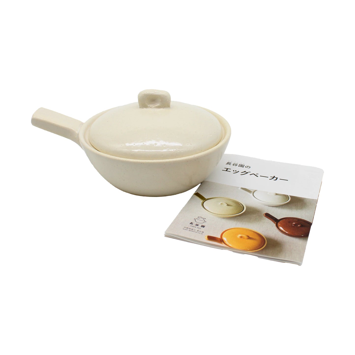 
                  
                    A Mini Baking Dish - White, crafted from cream-colored ceramic and featuring a lid and handle, is displayed next to a booklet showcasing photos of similar Japanese mini baking dishes in various colors.
                  
                