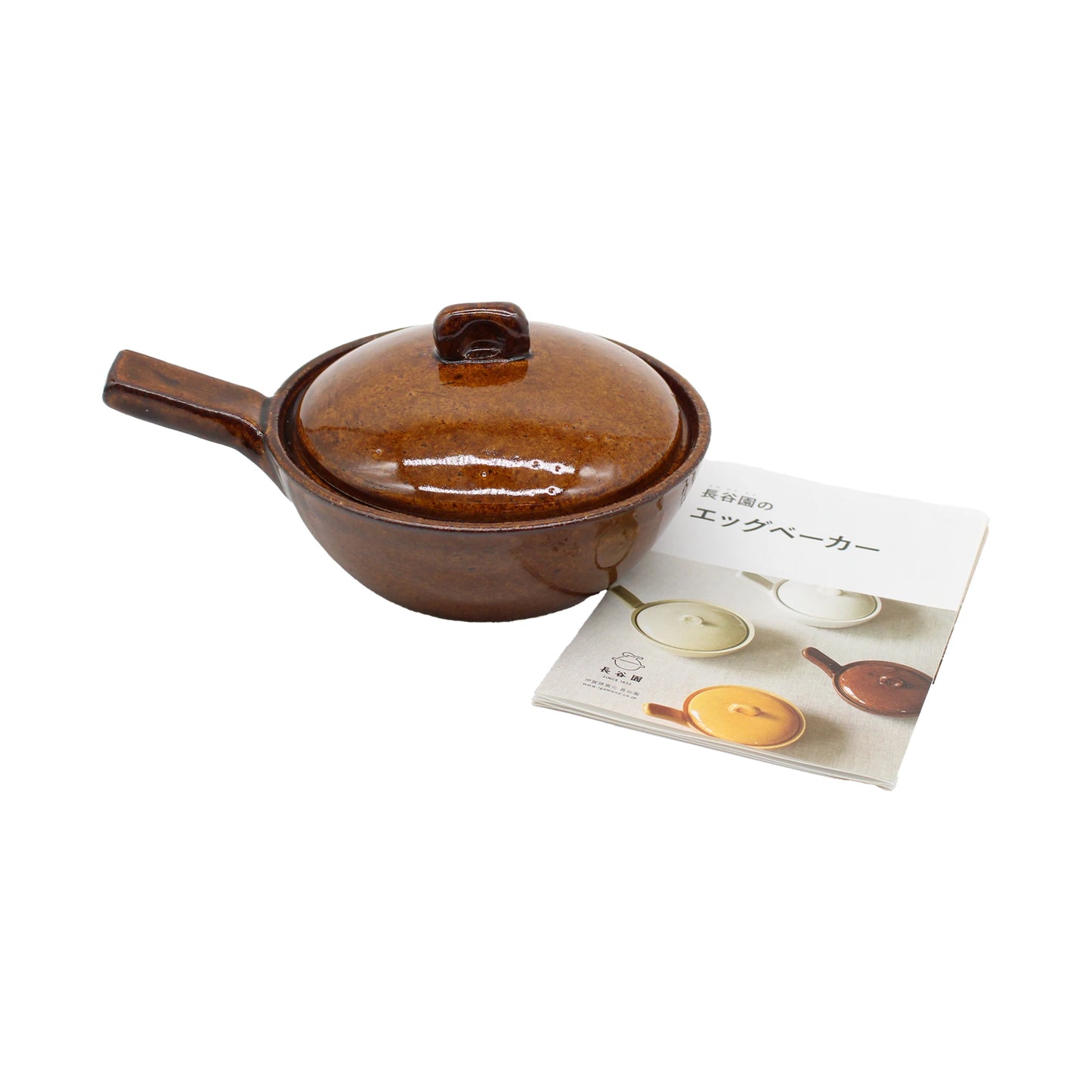 
                  
                    The Mini Baking Dish - Ame, a brown ceramic pot with a lid and handle that’s safe for oven and microwave use and ideal for individual baked dishes in Japanese style, is pictured next to a booklet with images of similar pots and Japanese text on the cover.
                  
                
