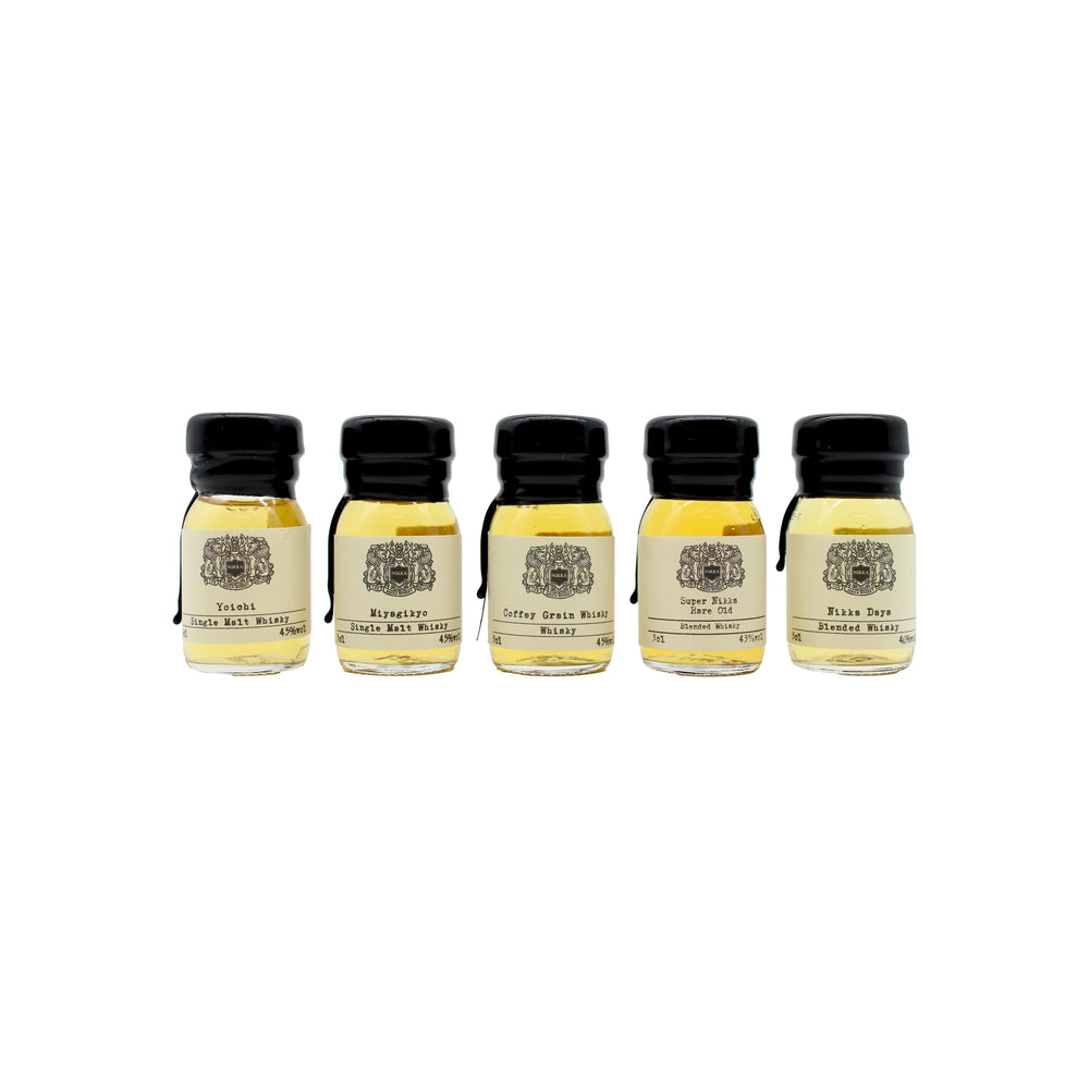 
                  
                    The Nikka Whisky Tasting Set includes five small glass bottles with black caps, each holding light amber Japanese whisky and featuring cream-colored labels with text and a decorative emblem—ideal for tastings.
                  
                