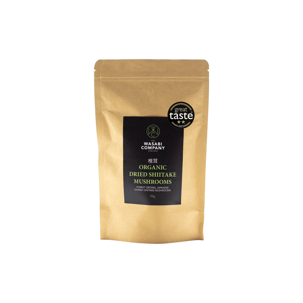A brown resealable pouch labeled Wasabi Label Organic Dried Donko Shiitake Mushrooms - 70g features premium forest-grown dried shiitake mushrooms and a Great Taste award badge on the top right.