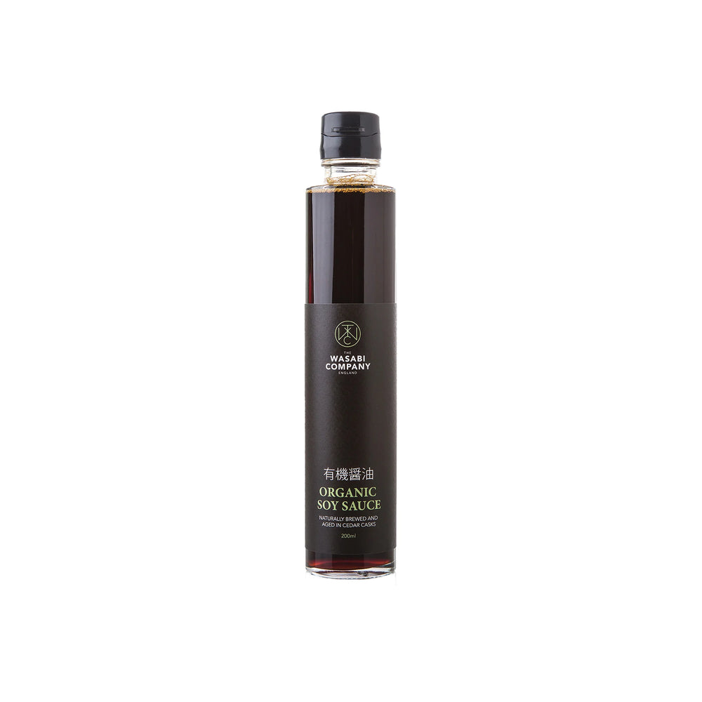 A clear glass bottle of Organic Soy Sauce - 200ml with a black label and black cap is photographed on a white background.