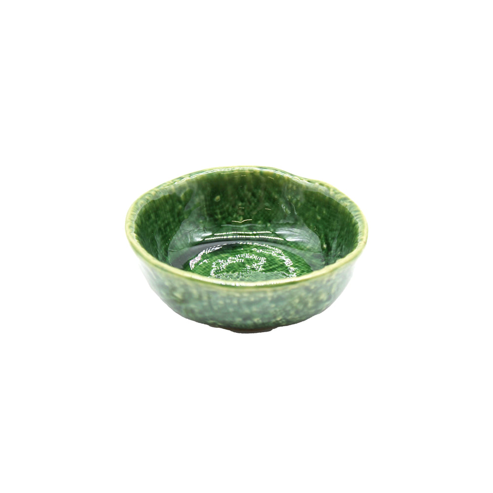 The Soy Sauce Dish - Oribe Green is a small, round ceramic bowl with a glossy, textured green finish inspired by Oribe ware, shown against a white background.