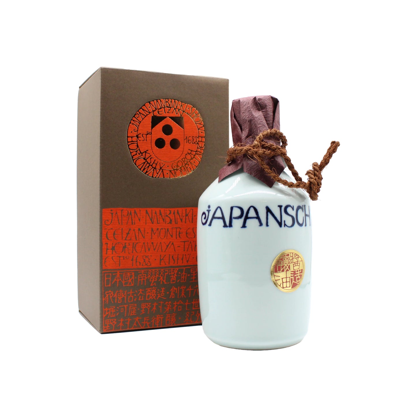 The Premium Mitsuboshi Shoyu Soy Sauce Carafe (900ml) features a white ceramic bottle with JAPANSCH label, gold seal, brown paper-wrapped top, and a box adorned with red-orange Japanese motifs—showcasing artisanal soy sauce made via the te-koji method.