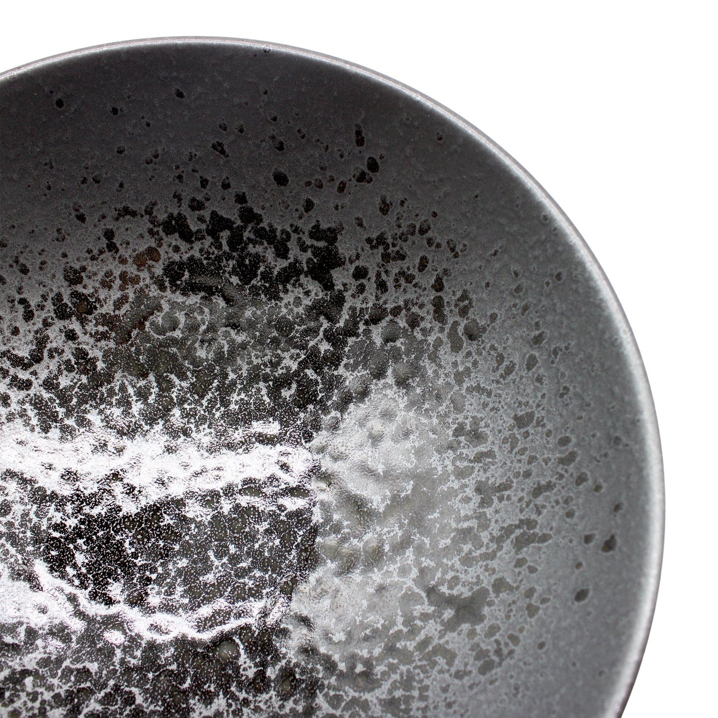 Close-up of the Ramen Bowl - Black Pearl, a dark, round Minoyaki porcelain bowl with a matte speckled interior by Ichi kiln, set against a white background.