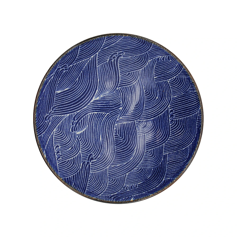 The Ramen Bowl - Blue Wave is a round Minoyaki porcelain bowl with a blue background, featuring an abstract pattern of white curved lines.
