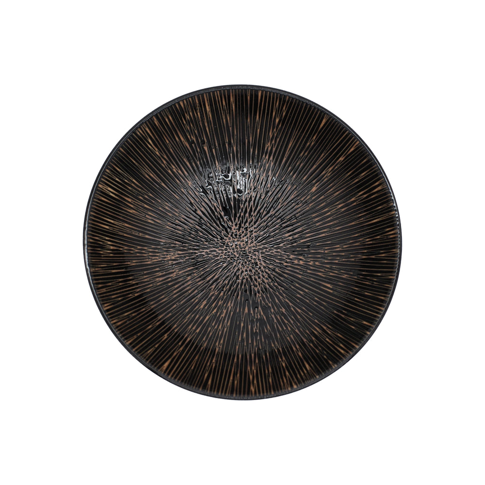 
                  
                    The Ramen Bowl - Bronze is a round, black handmade bowl featuring a textured bronze radiating line pattern, inspired by Japanese ramen bowls and shown from above on a white background.
                  
                