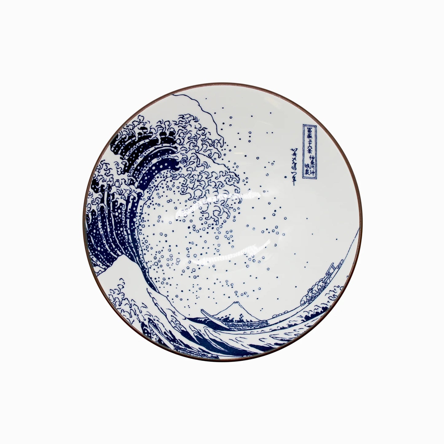 A ceramic ramen bowl called Ramen Bowl - Great Wave Design White, featuring a blue and white Japanese motif inspired by Hokusai’s “The Great Wave off Kanagawa,” with wave patterns and Mount Fuji.