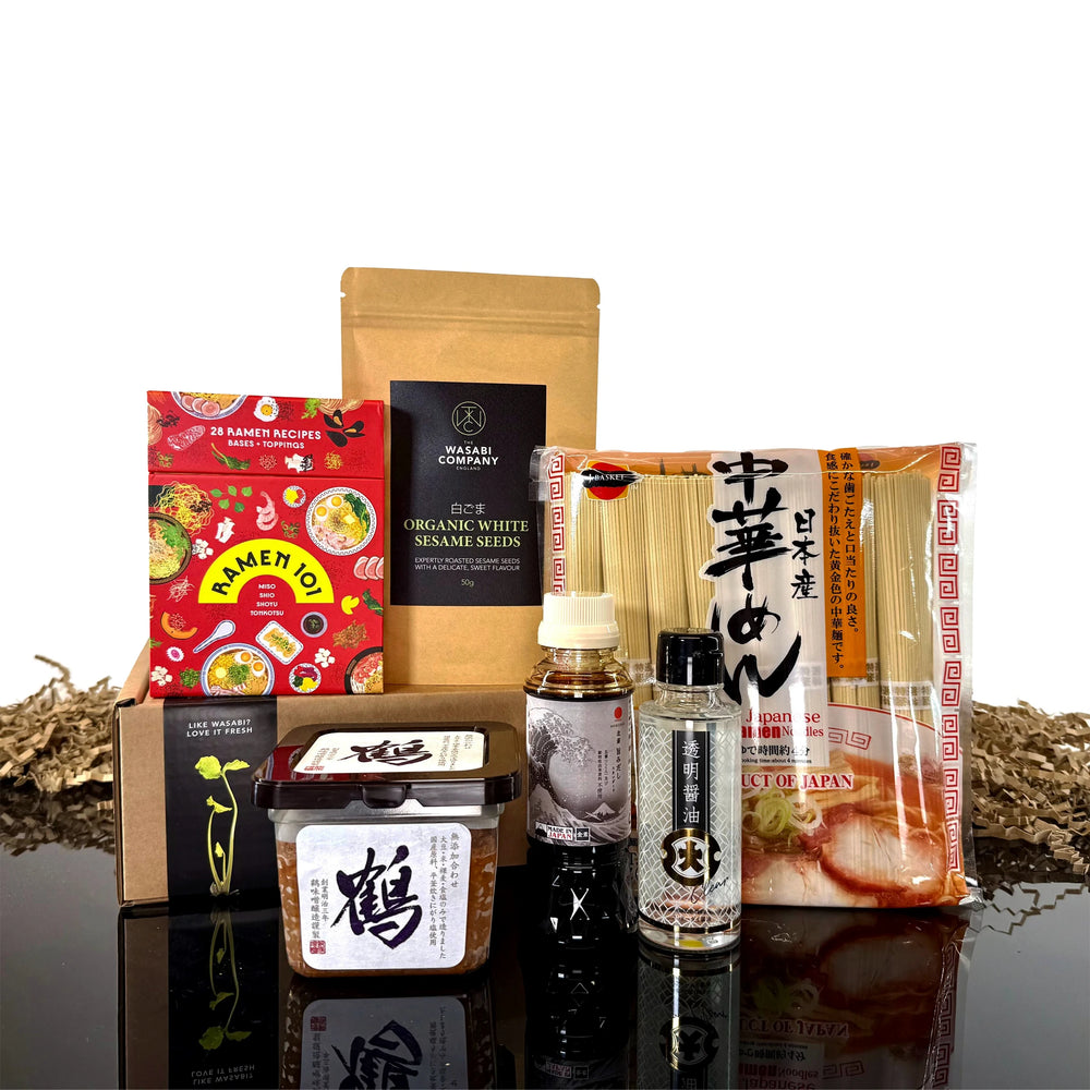 The Ramen Set with Ramen 101 Gift Cards features assorted Japanese noodles, sauces, miso paste, and seasonings artfully arranged—ideal for crafting a personalized ramen kit at home.