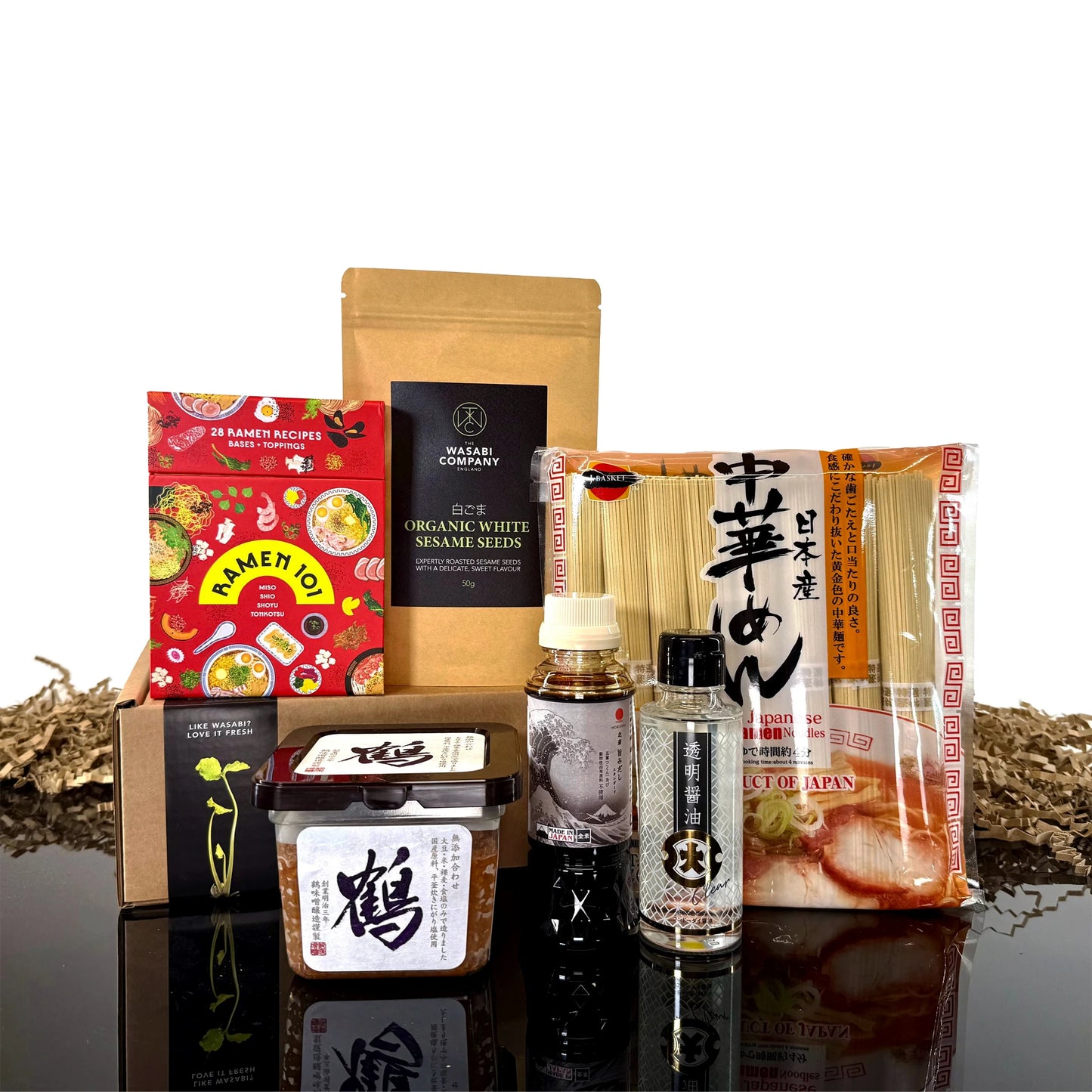 The Ramen Set with Ramen 101 Gift Cards features assorted Japanese noodles, sauces, miso paste, and seasonings artfully arranged—ideal for crafting a personalized ramen kit at home.