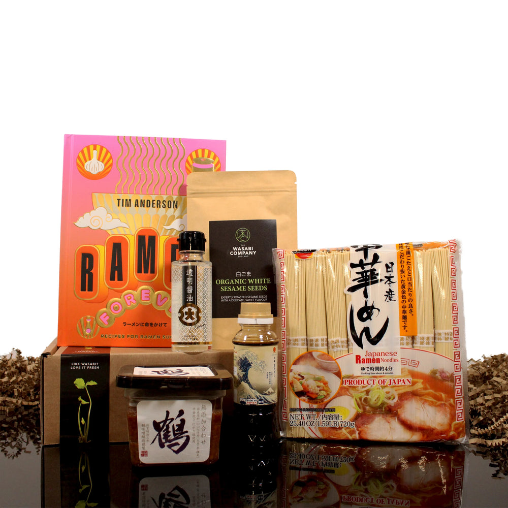The Ramen Set with Ramen Forever Cook Book features Japanese ramen ingredients like noodles, Barley Miso, and sauces, all displayed against a black background.