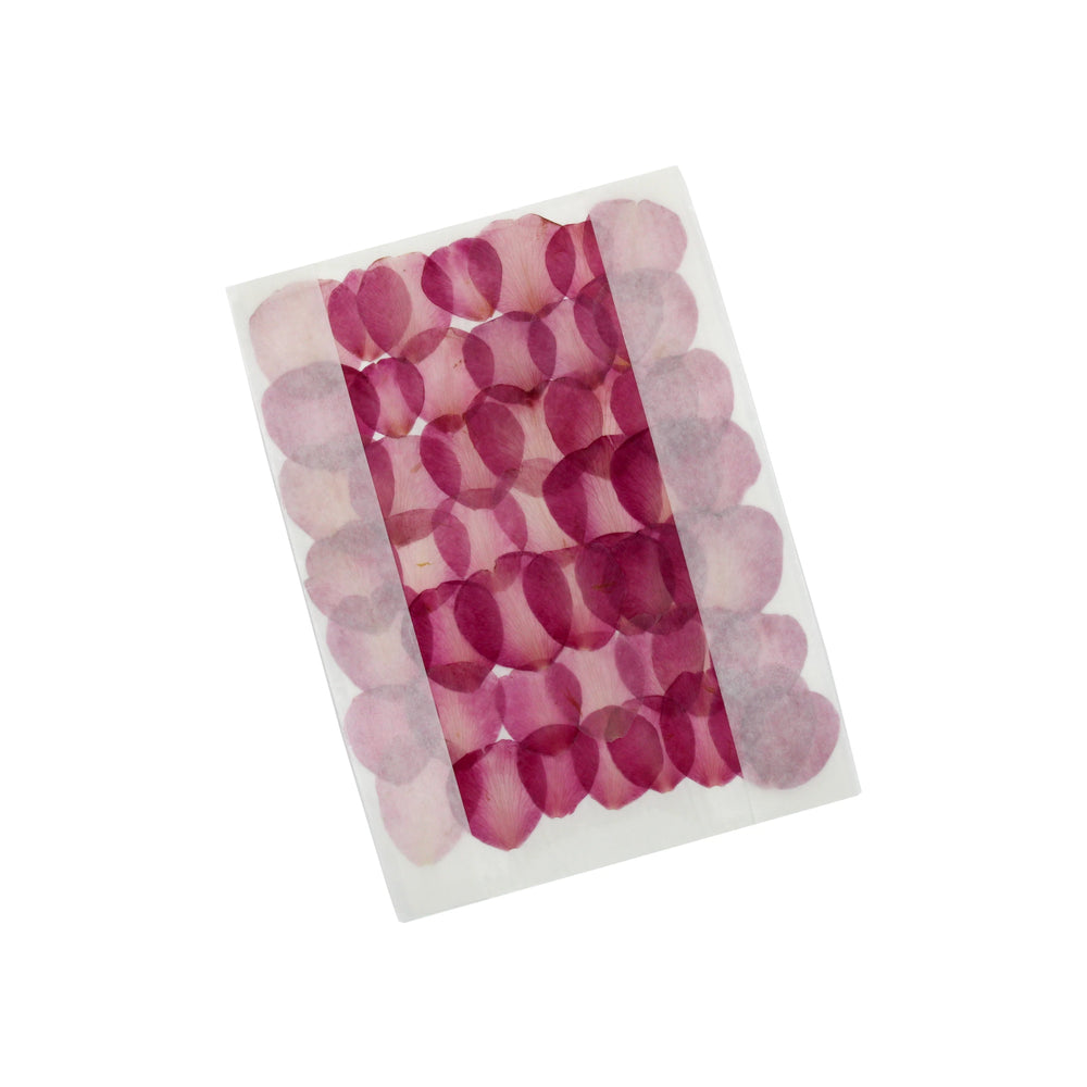 A rectangular sheet displays rows of overlapping, translucent pink and purple ovals resembling the Red Camelia Petals, Dried & Edible – 100, arranged on a white background.