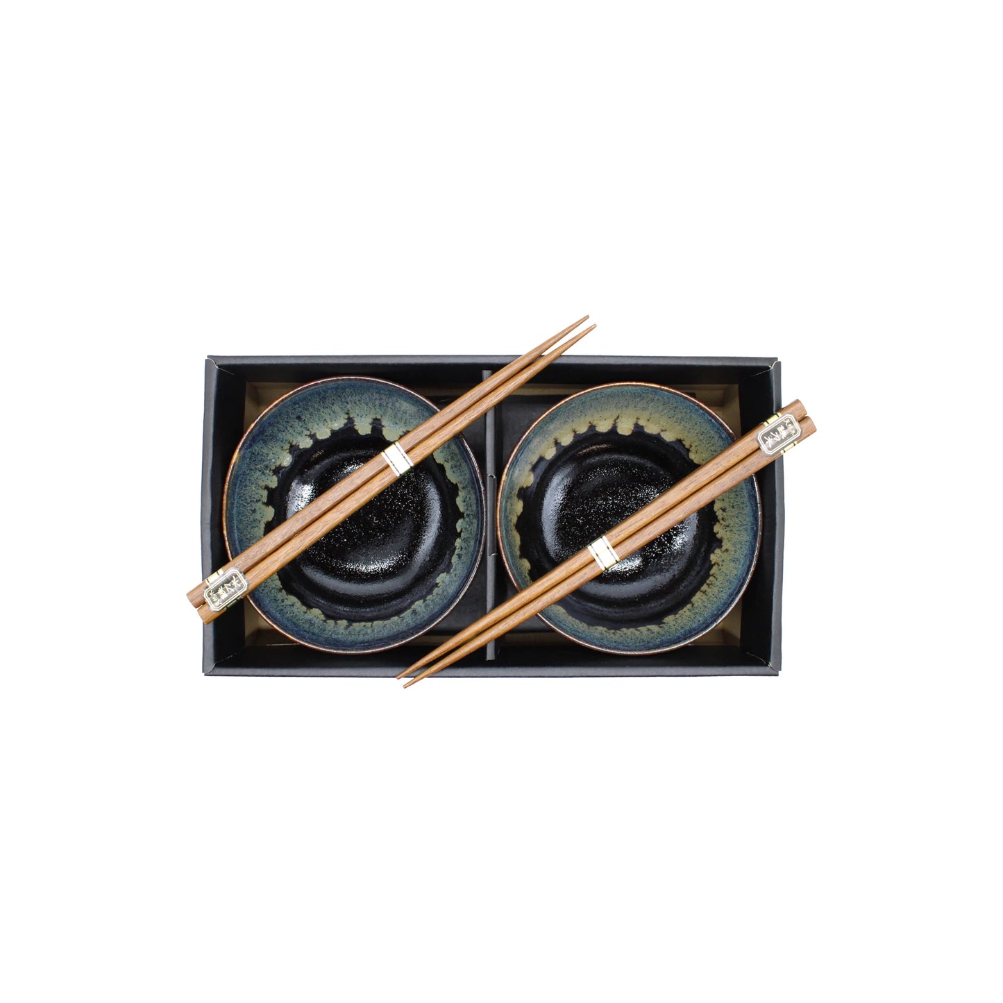 The Black Cascade Bowls Gift Set includes two ceramic bowls with a dark green and black glaze, each paired with wooden chopsticks—a stylish addition to any Japanese tableware collection.
