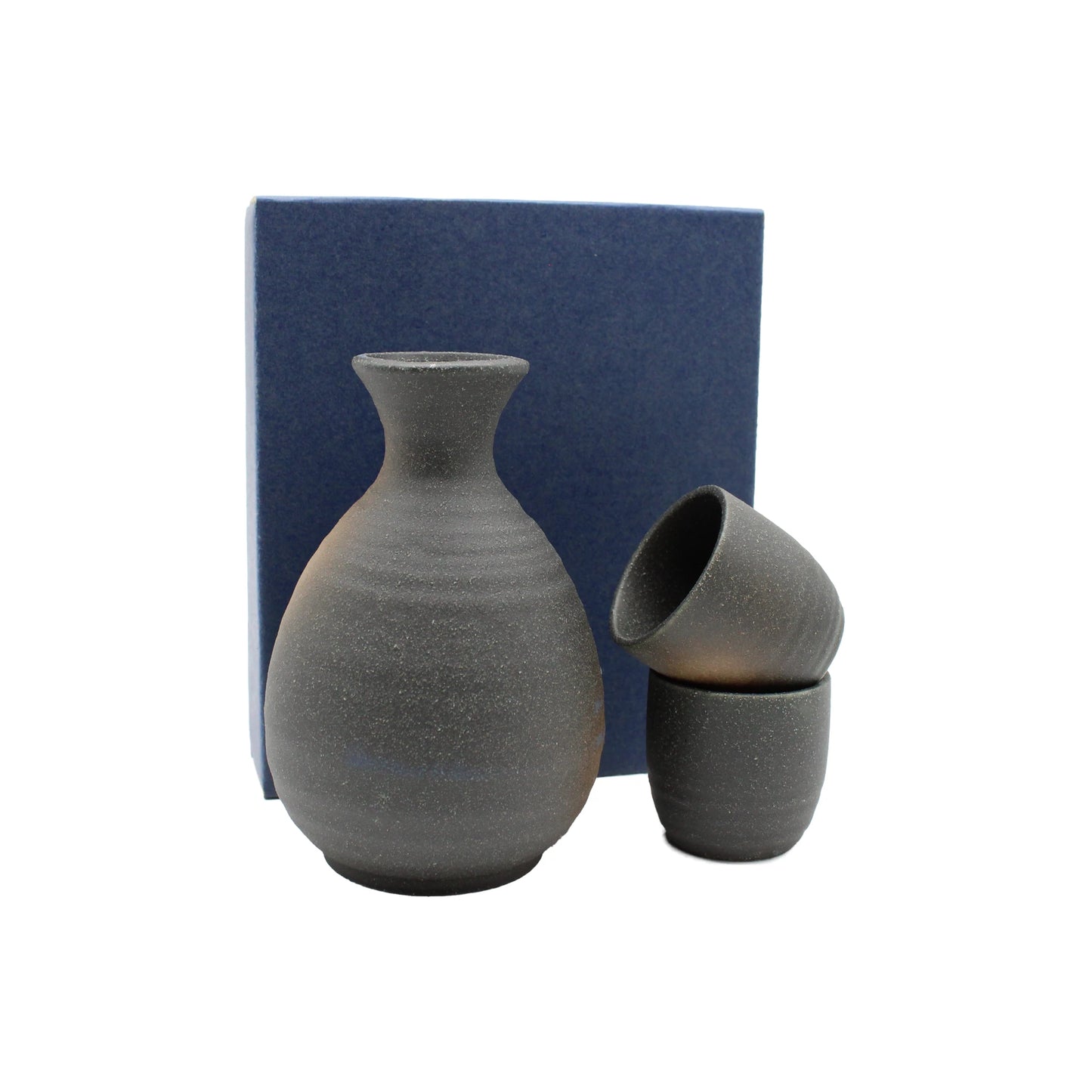 The Sake Gift Set For Two - Black Bizen, including a carafe and two cups, is displayed before a blue box on a white background.