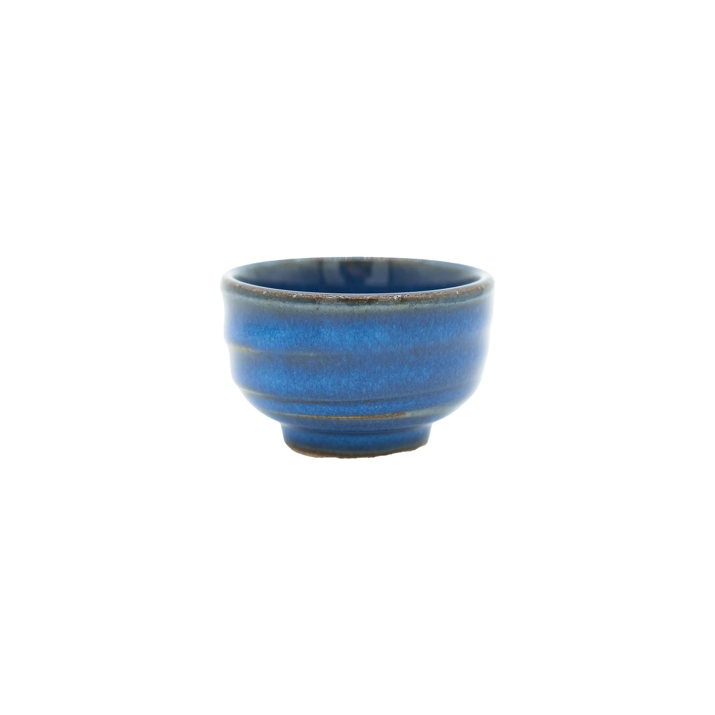 The Sake Cup - Bright Blue is a small Minoyaki porcelain sake cup with a vibrant blue glaze, subtle horizontal lines, and a slightly raised base, displayed against a plain white background.