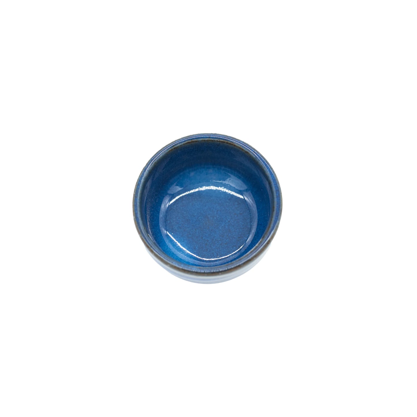 
                  
                    The Sake Cup - Bright Blue is a small, round Minoyaki porcelain cup featuring a glossy bright blue glazed interior, shown from above on a plain white background.
                  
                