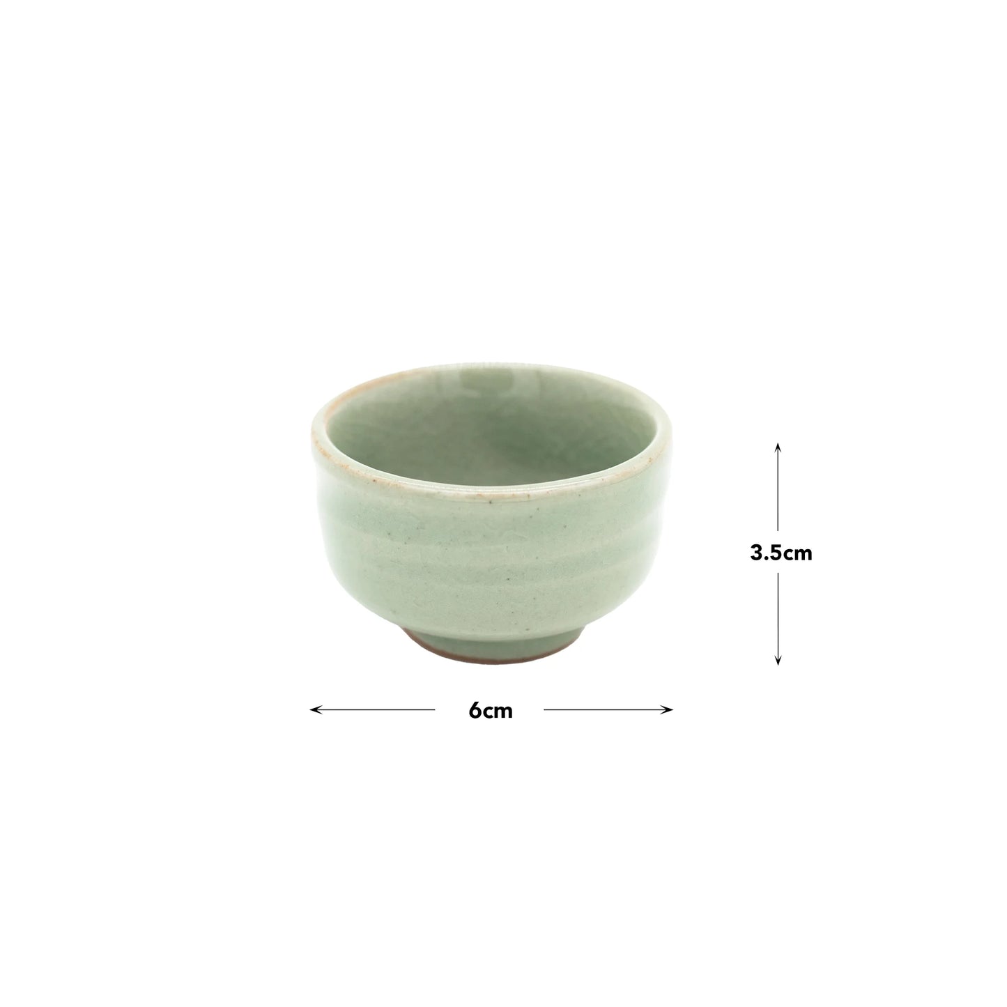The Sake Cup - Celadon Green is a small, round Minoyaki porcelain cup in light green celadon, measuring 6 cm wide by 3.5 cm tall and shown on a plain white background.