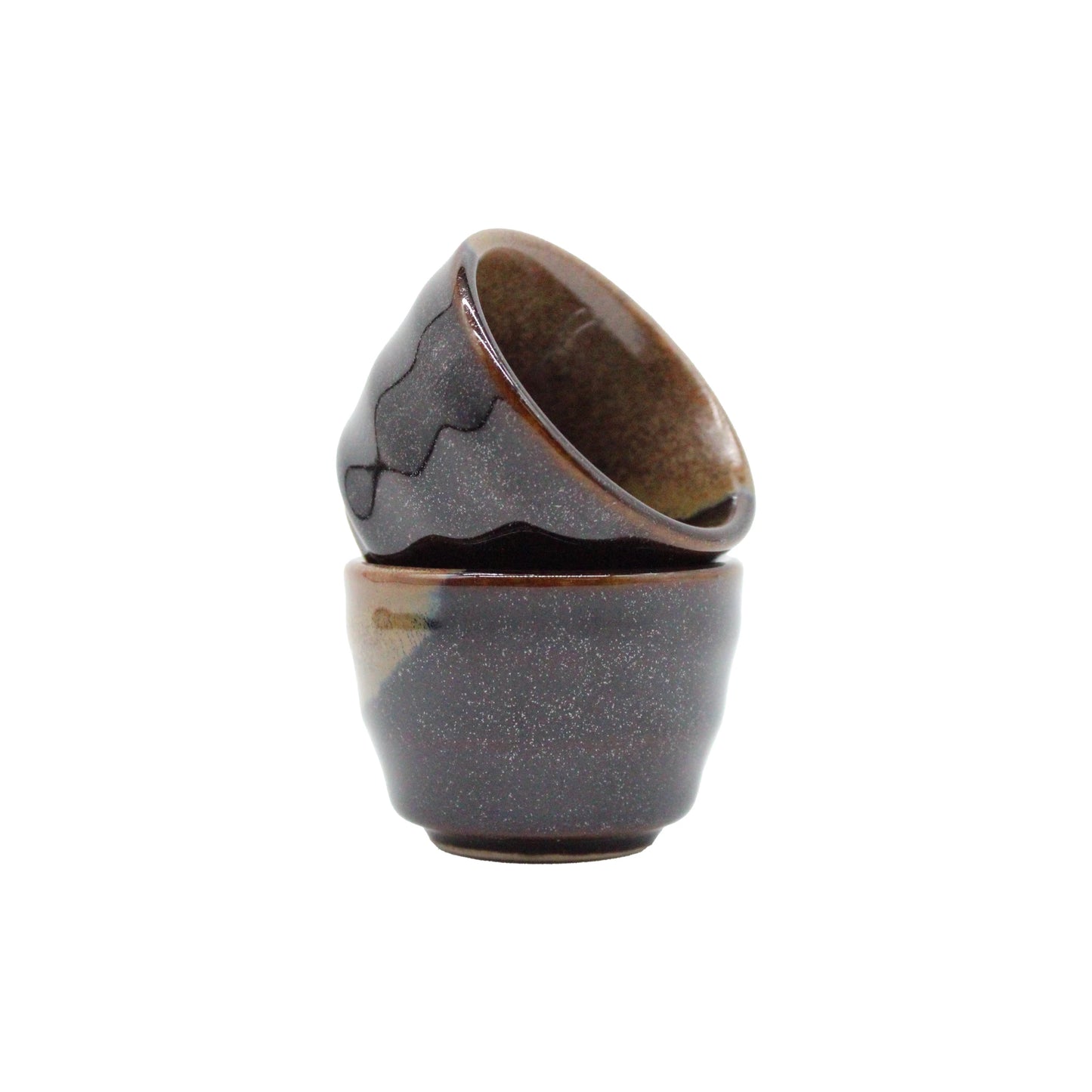 
                  
                    A set of four Japanese ceramic sake cups are stacked against a white background—perfect for enjoying Konishi Gold Sake.
                  
                