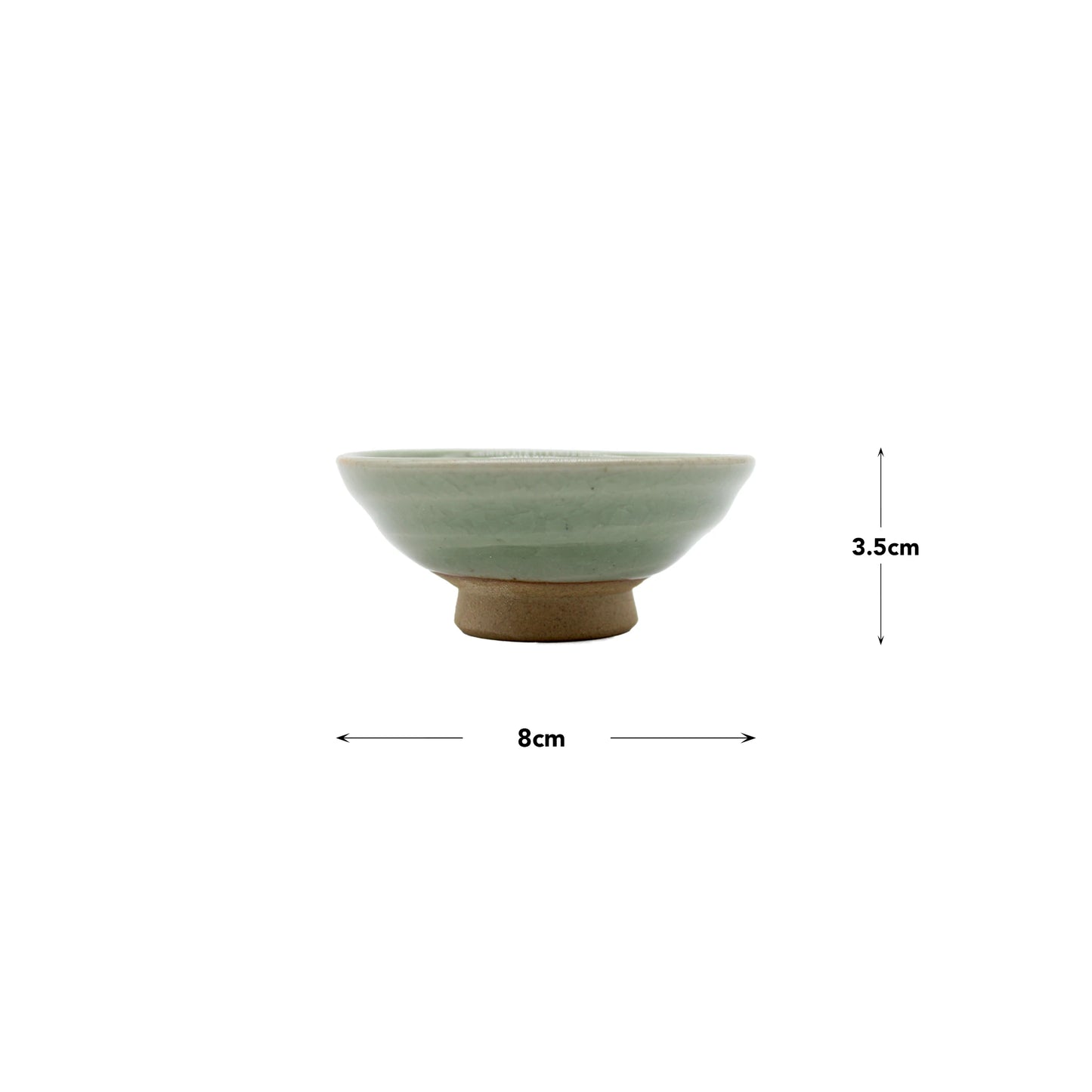 
                  
                    The Sake Cup - Flat Sakazuki in Celadon Green is a small ceramic bowl featuring a light green celadon glaze, measuring 8 cm in diameter and 3.5 cm in height.
                  
                
