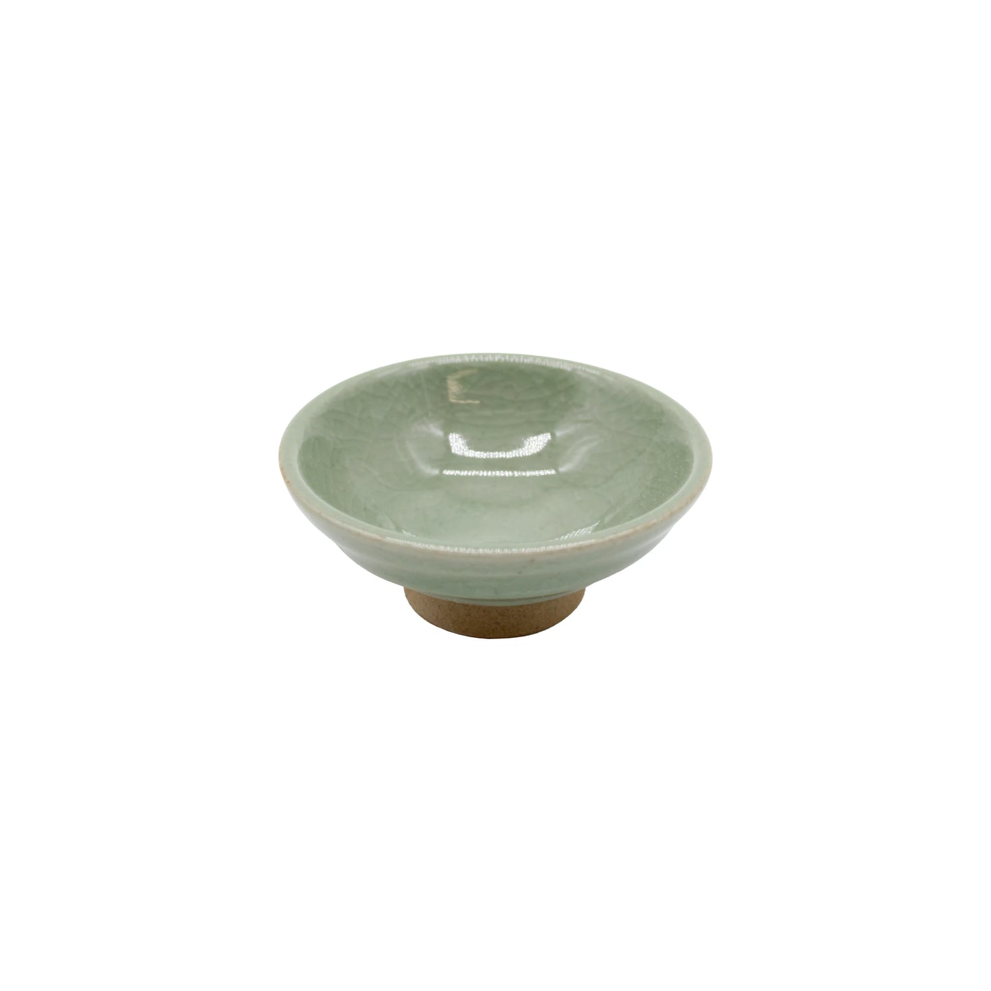 
                  
                    A small, flat Sakazuki-style sake cup named "Sake Cup - Flat Sakazuki in Celadon Green", featuring a light green celadon glaze and a slightly raised base, displayed on a white background.
                  
                