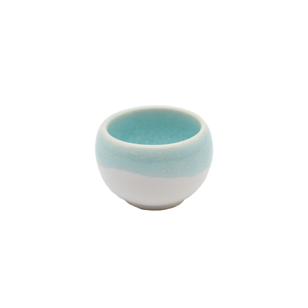 The Minoyaki Seiryuu Sake Cup is a small, round cup crafted from Minoyaki pottery with a white base and light blue upper half, shown against a plain white background.