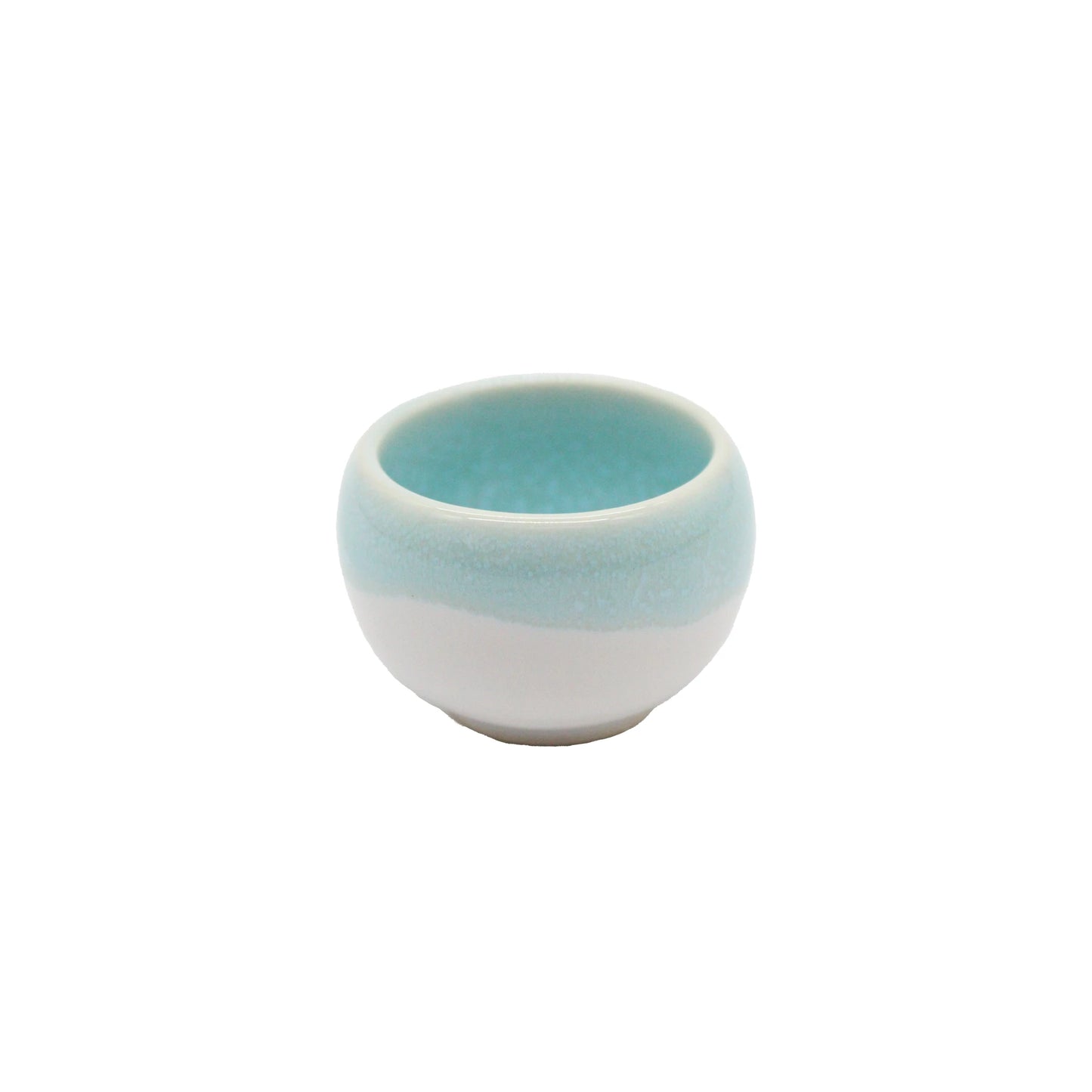 The Minoyaki Seiryuu Sake Cup is a small, round cup crafted from Minoyaki pottery with a white base and light blue upper half, shown against a plain white background.
