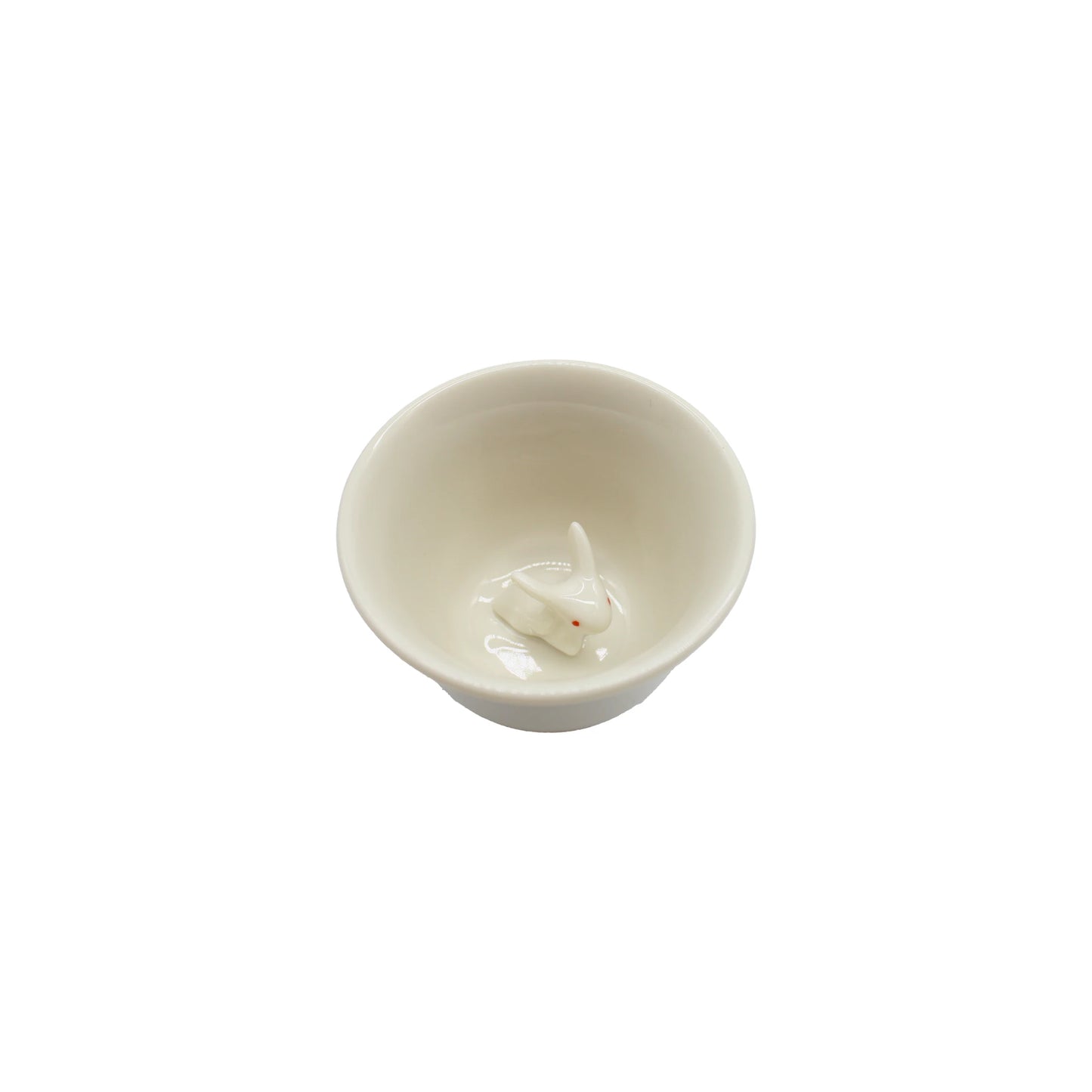 
                  
                    Sake Cup Boxed Set - Rabbit Design: A white ceramic sake cup featuring a delicate white rabbit motif figurine at the bottom, evoking the charm of traditional Japanese drinkware, photographed on a white background.
                  
                