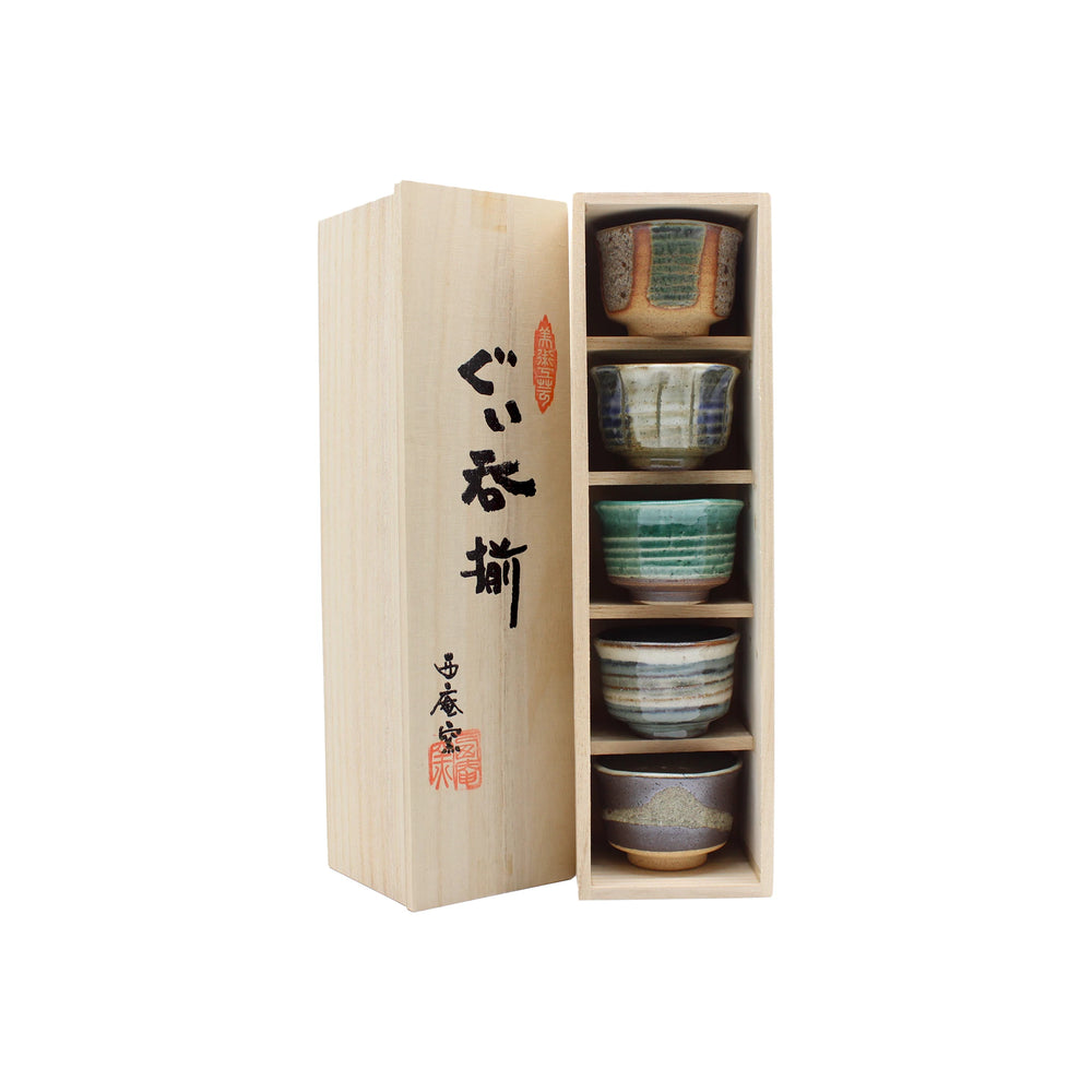 The Ochoko Sake Cups - Set of 5 come in a wooden box with Japanese calligraphy and feature five uniquely patterned cups inspired by traditional Japanese ceramics.