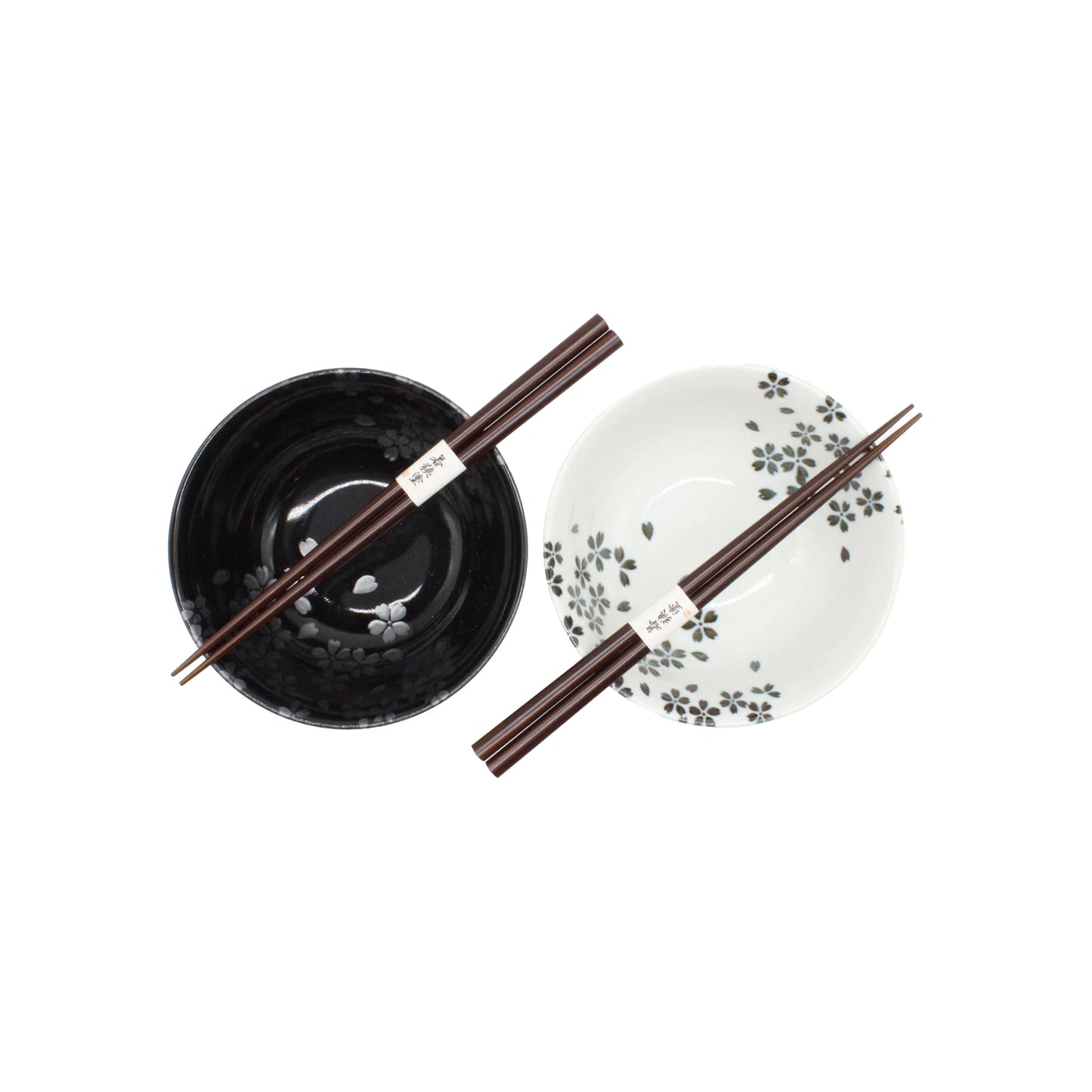 
                  
                    The Sakura Blossom Bowls Gift Set – Black & White features two ceramic bowls, one black and one white, each with a pair of chopsticks and a sakura motif, beautifully presented on a white background.
                  
                
