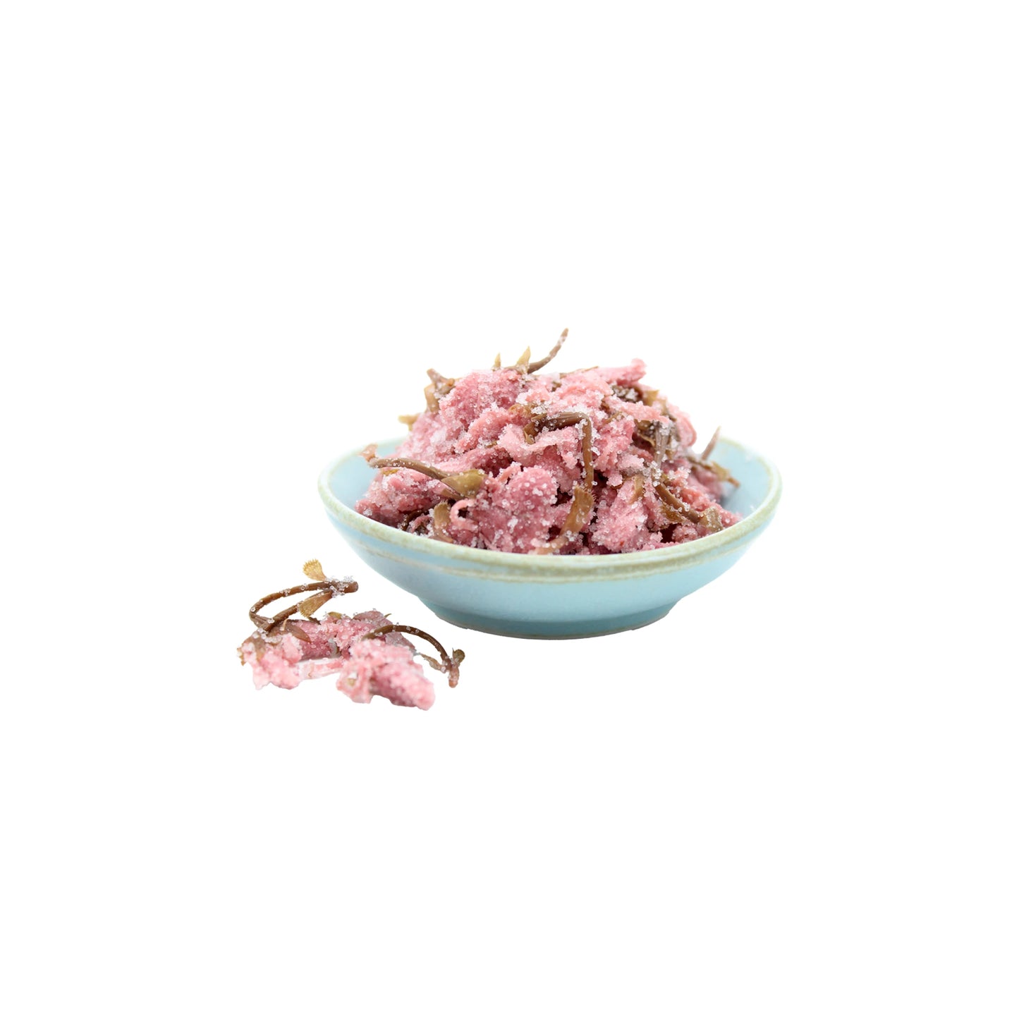 A small blue bowl holds a pinkish shredded mix with thin brown strips, resembling the ingredients of Salted Cherry Blossom Tea - 40g, set against a white background.