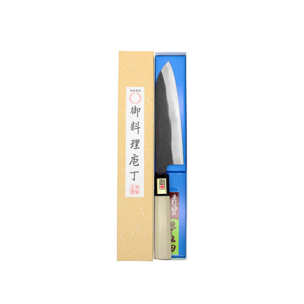
                  
                    The Santoku Multi-Purpose Knife Black Forged 180mm features a wooden handle and dark double-bevel edge blade, comes in a yellow box with Japanese writing, and is displayed against a white background.
                  
                