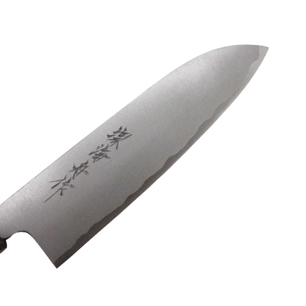 
                  
                    A close-up of the Santoku Multi-Purpose Knife Migaki Polished - 180mm, showcasing engraved kanji and a wavy edge pattern on its Japanese all-purpose blade.
                  
                