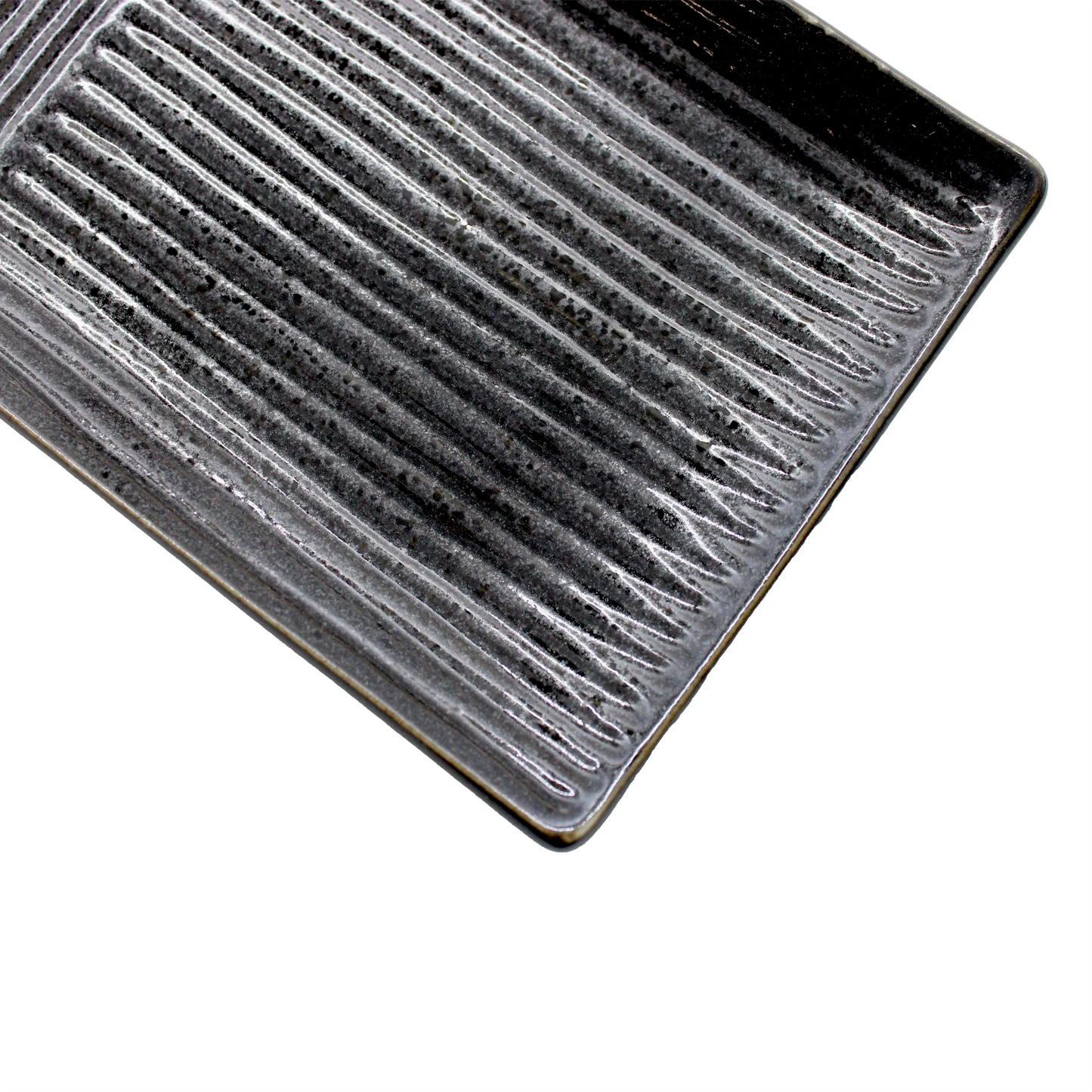 The Sashimi Platter - Line Design Black is a rectangular ceramic serving plate with ribbed, textured surface and rounded edges. Its sleek black glaze brings Japanese elegance to any table setting. Shown from above on a white background.