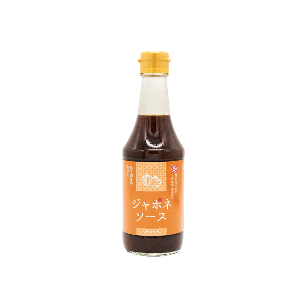 Sauteed Onion Sauce - 300ml comes in a glass bottle with a yellow cap and Japanese labeling on an orange background—ideal as a marinade for steak or grilled meats.