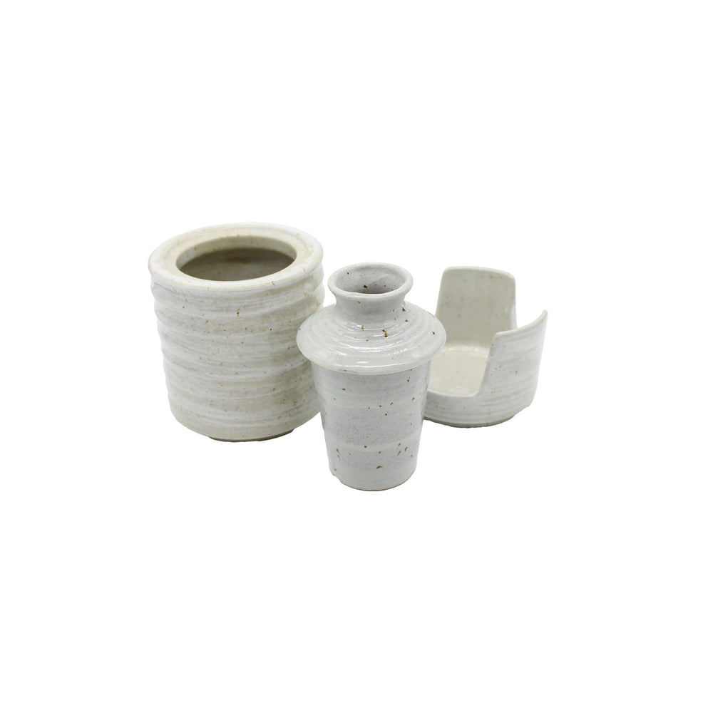 The Ceramic Seiji Sake Warmer, a minimalist white ceramic vessel with an open-sided design inspired by traditional sake sets, is displayed on a white background.