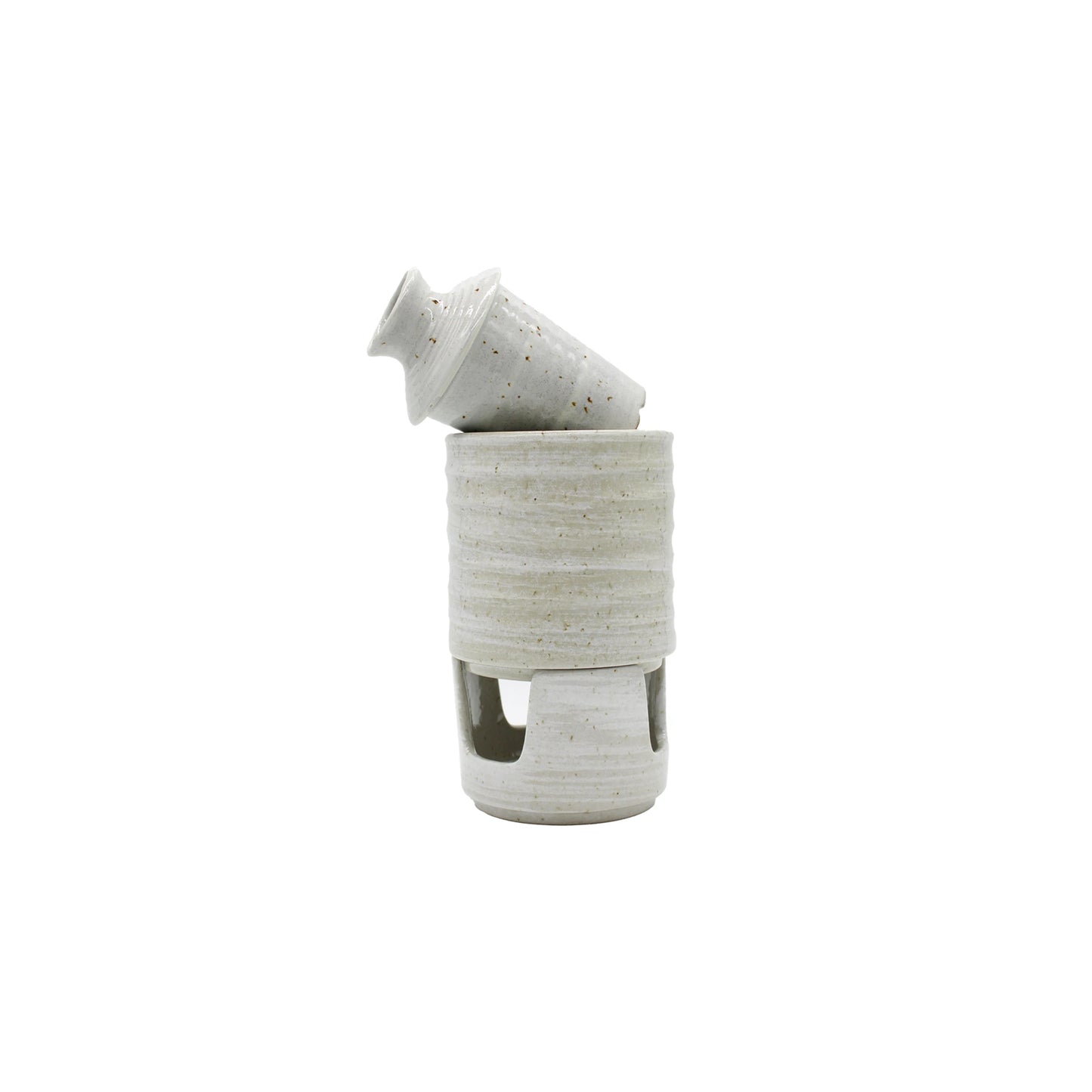 
                  
                    The Ceramic Seiji Sake Warmer features a small, speckled Seiji glaze bottle resting at an angle in a matching round open-base holder, creating a modern and charming sake set on a white background.
                  
                
