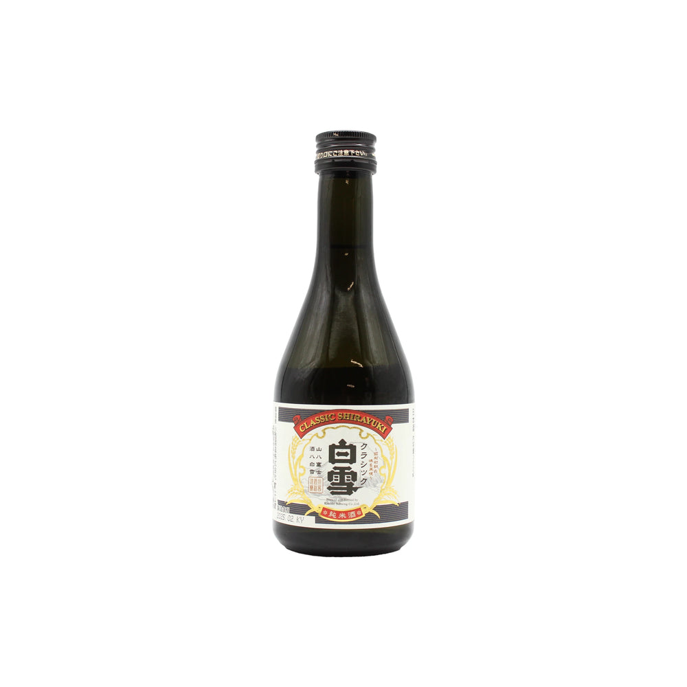 A dark glass bottle of Shirayuki Classic Junmai - 300ml with a white and gold label, set against a plain white background, evokes the refined taste of traditional Japanese sake enjoyed for generations.