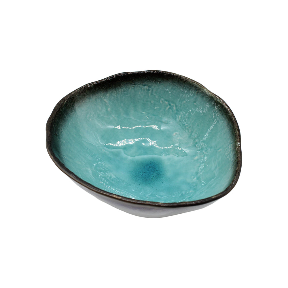 
                  
                    The Large Uneven Bowl - Sky Blue is a handmade Minoyaki porcelain bowl with an irregular rim, a sky blue glazed interior, and a dark textured exterior. Crafted in Gifu prefecture, it is photographed on a white background.
                  
                