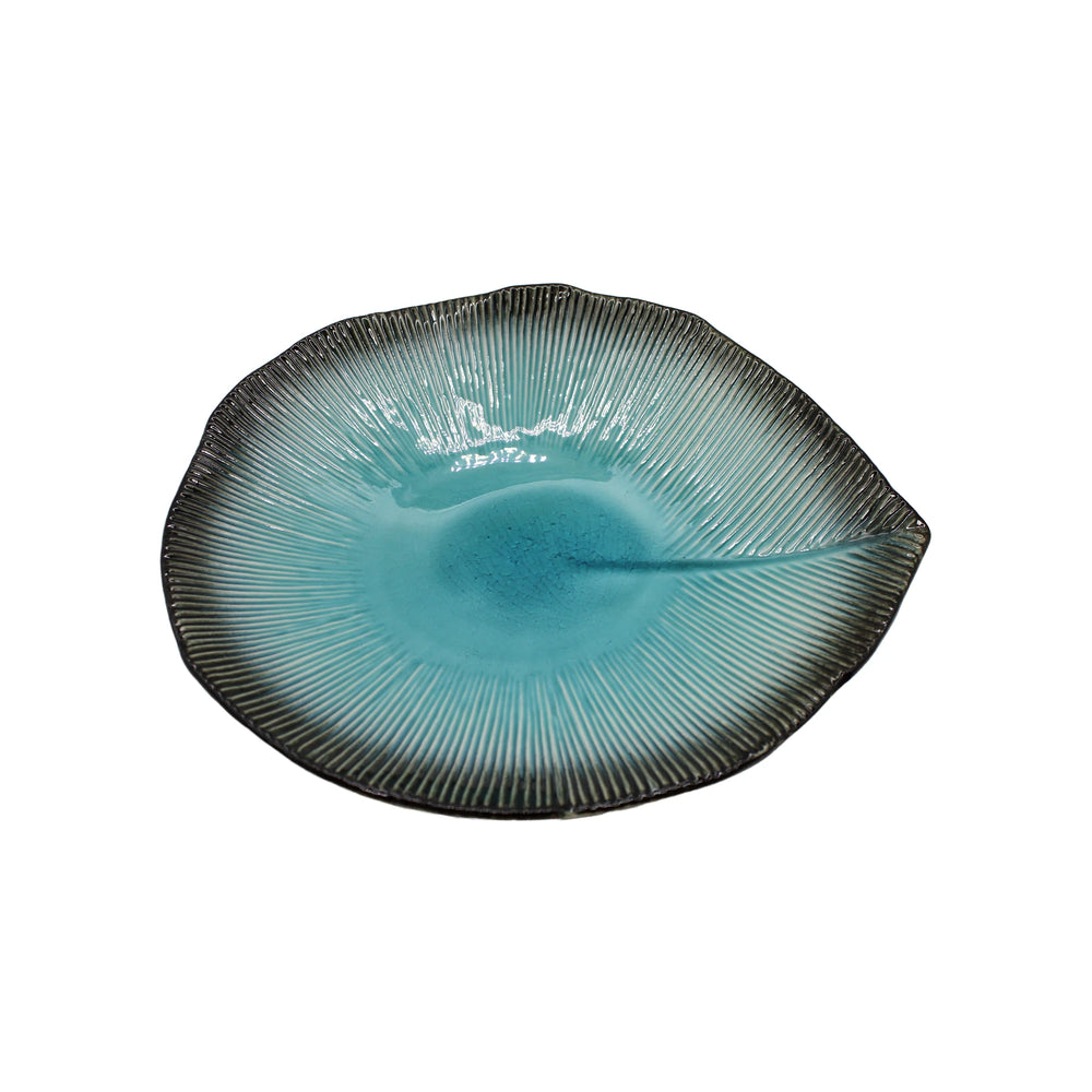 The Shallow Serving Bowl - Sky Blue features a round, textured Minoyaki porcelain design with a turquoise center fading into dark, ribbed edges and an irregular organic shape inspired by traditional Takai Kiln Japan artistry.