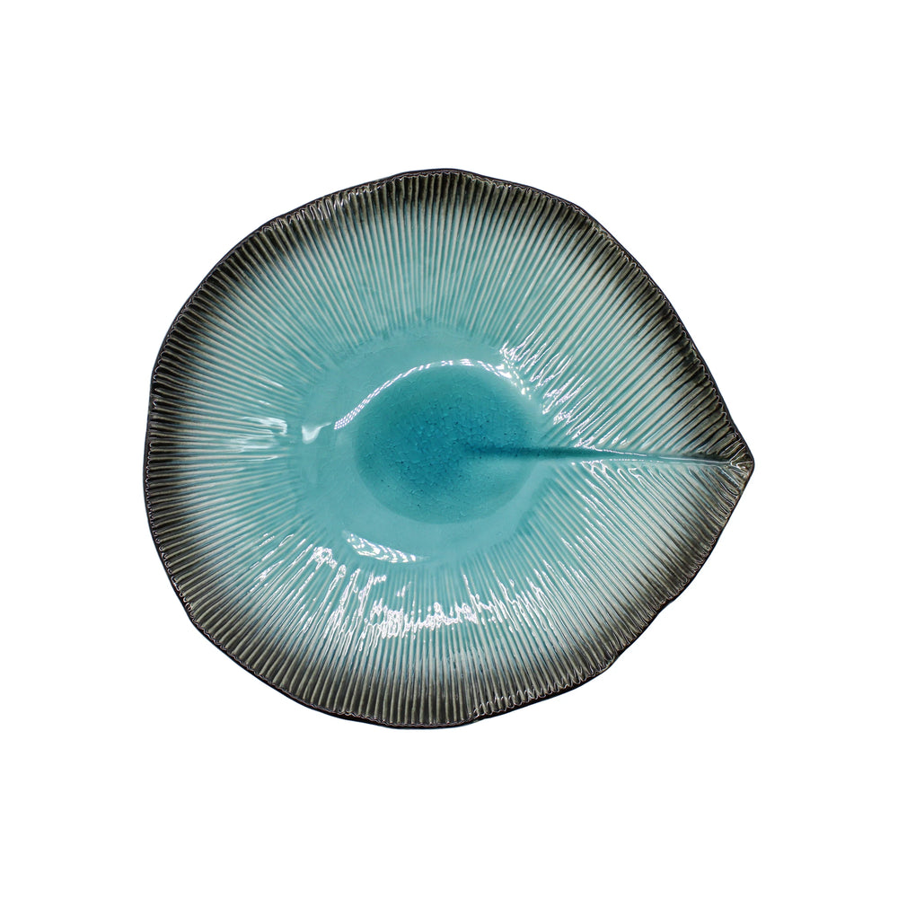 
                  
                    A sky blue, leaf-shaped Minoyaki porcelain shallow serving bowl with a textured surface and dark outer edge, photographed on a white background.
                  
                