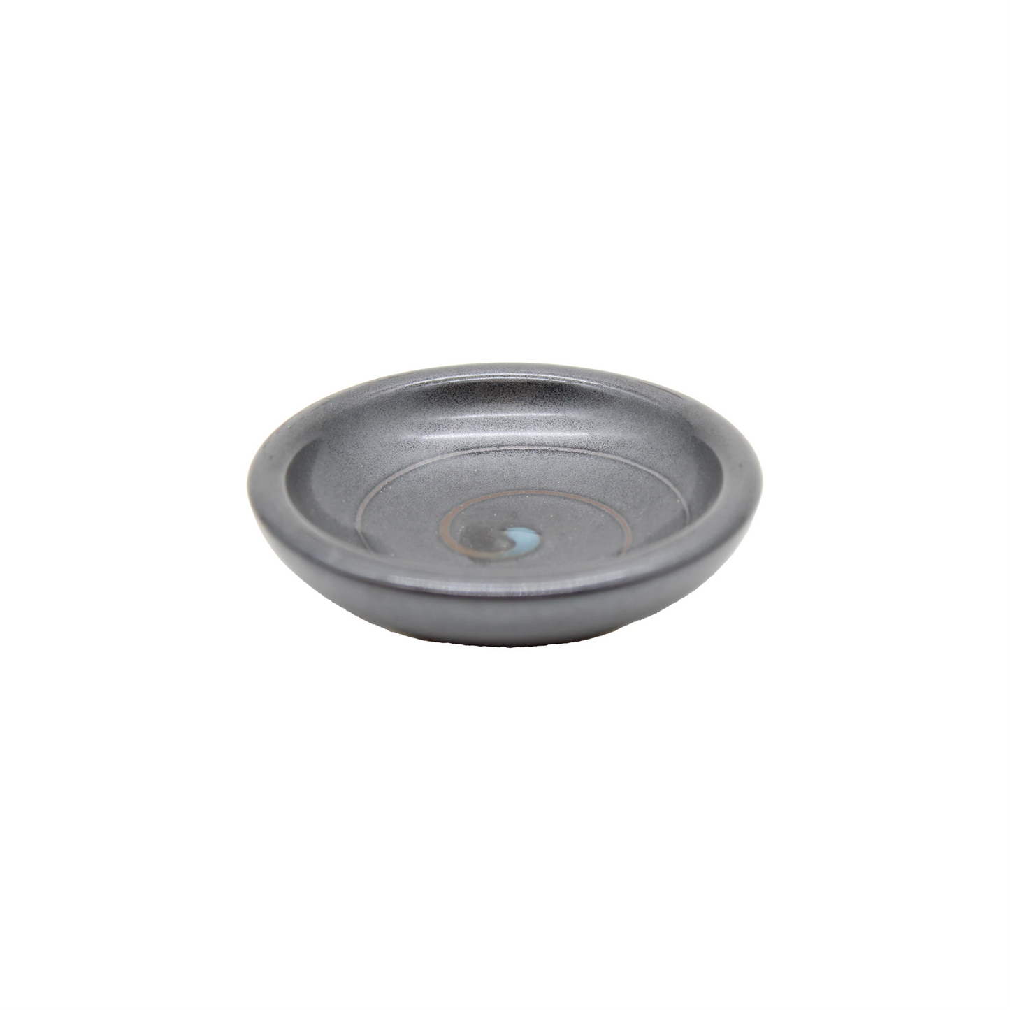 The Soy Sauce Dish - Black Vortex is a small, round, gray ceramic dish with a subtle spiral pattern and slightly raised rim, ideal for serving Japanese pickles, shown on a plain white background.