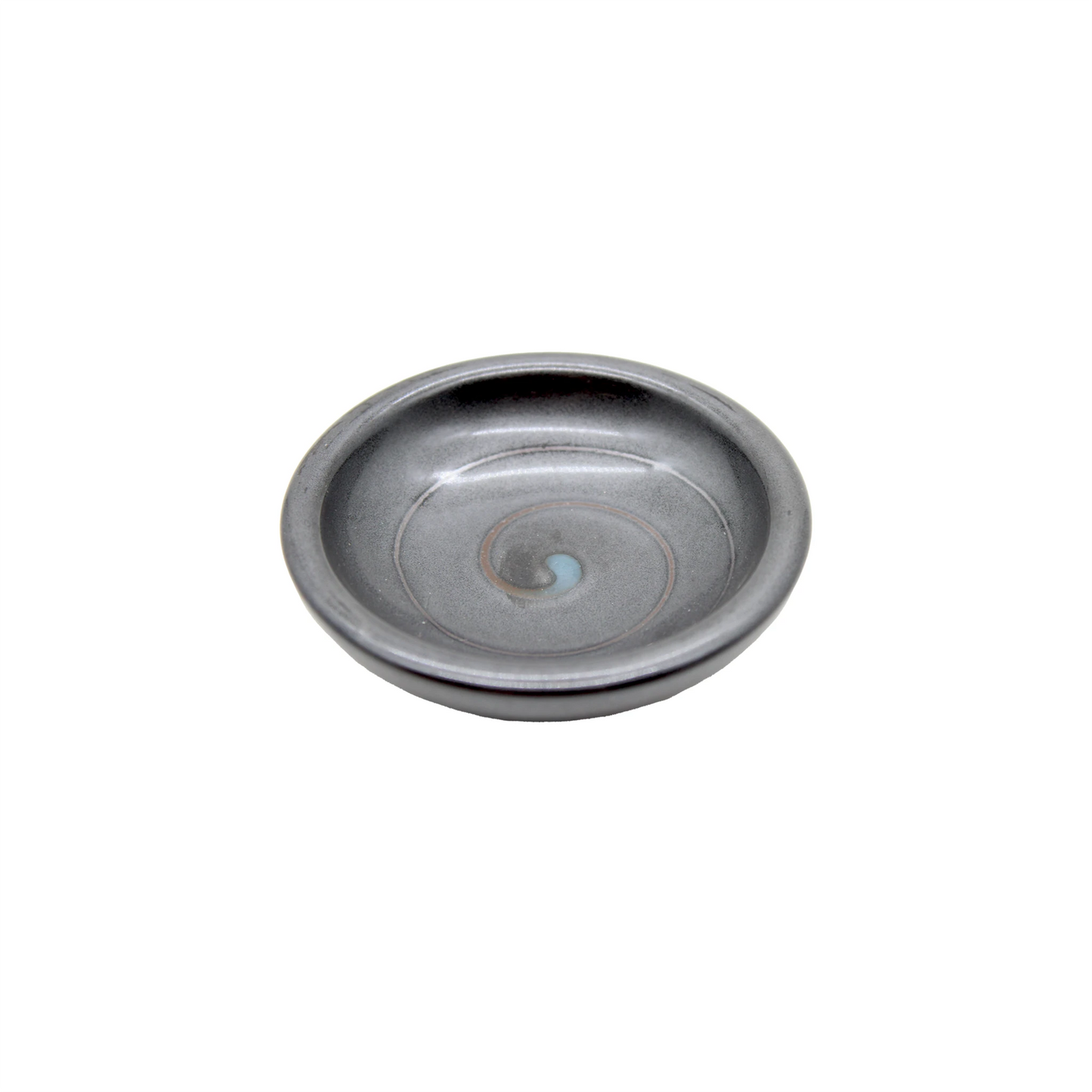
                  
                    The Soy Sauce Dish - Black Vortex is a small, round, shallow black dish featuring a smooth dark gray surface with a subtle spiral pattern, ideal for serving Japanese pickles. Shown against a white background.
                  
                