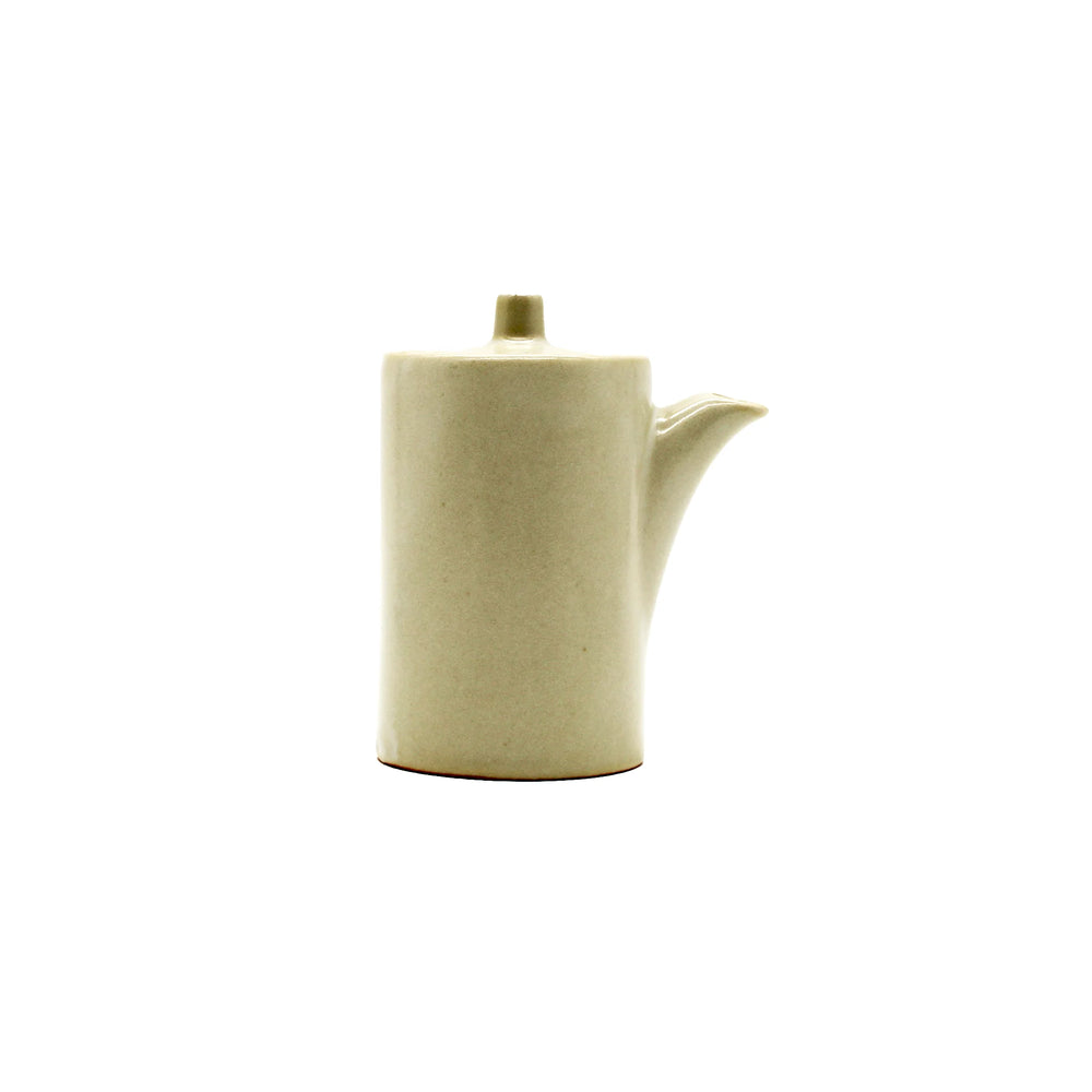 A minimalist, cylindrical Soy Sauce Pourer - Stone in cream-colored Minoyaki porcelain with a short spout and small lid, shown against a plain white background.