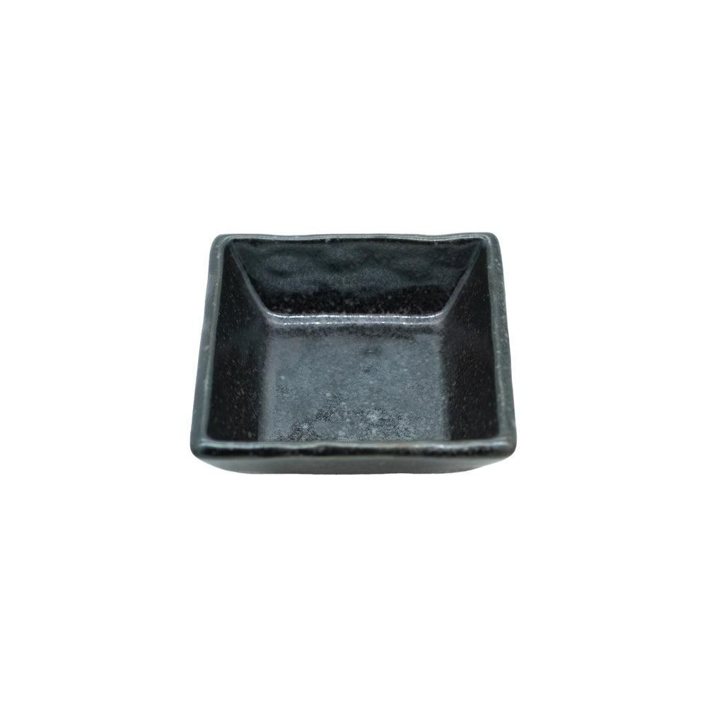 The Soy Sauce Dish - Square in Matt Black is a small, empty, square-shaped dish on a white background, ideal for serving condiments or sauces.