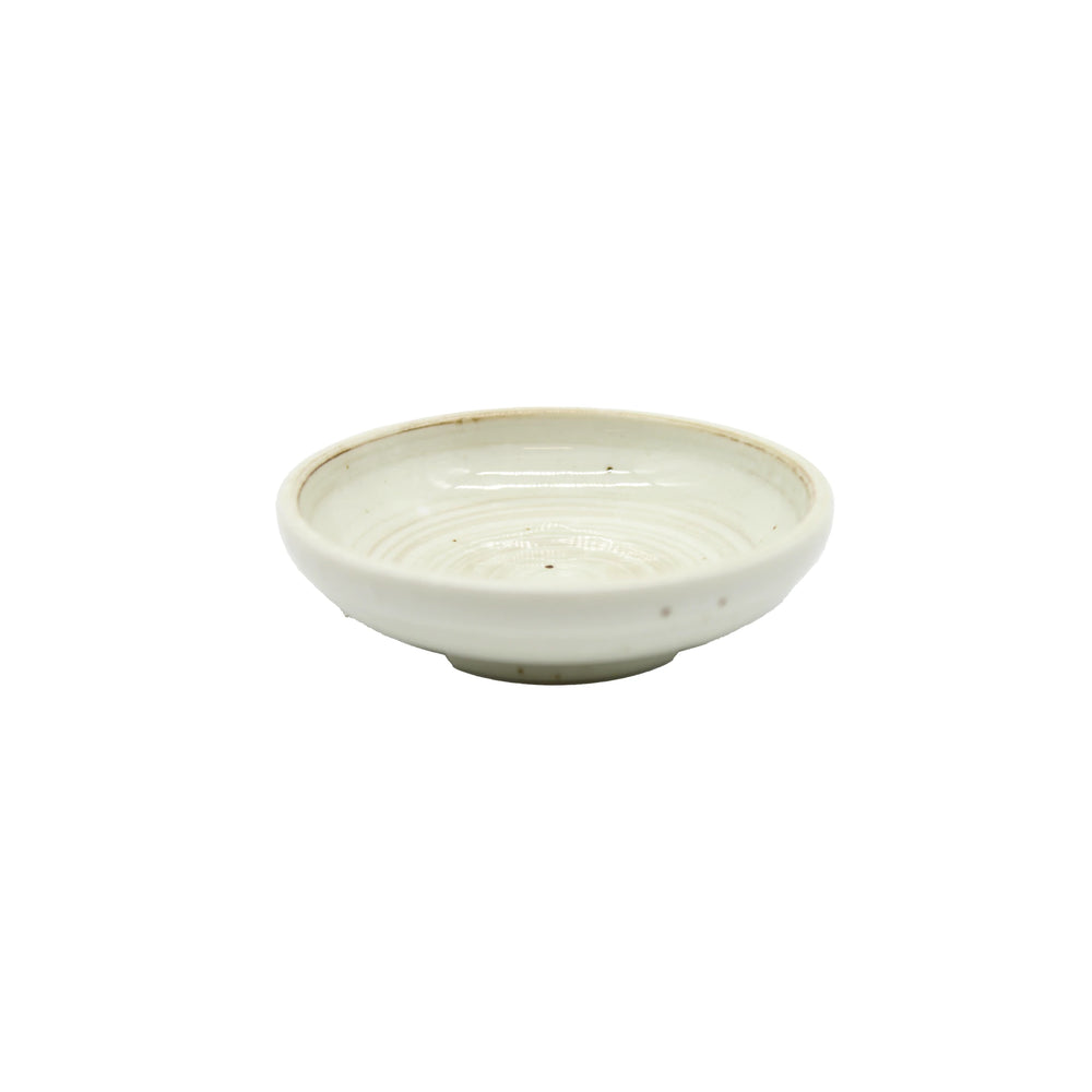 The Soy Sauce Dish - White Kohiki Vortex is a small, shallow, round ceramic dish with a smooth off-white glaze and subtle ridges, inspired by Japanese pottery and Kohiki ware, shown on a plain white background.